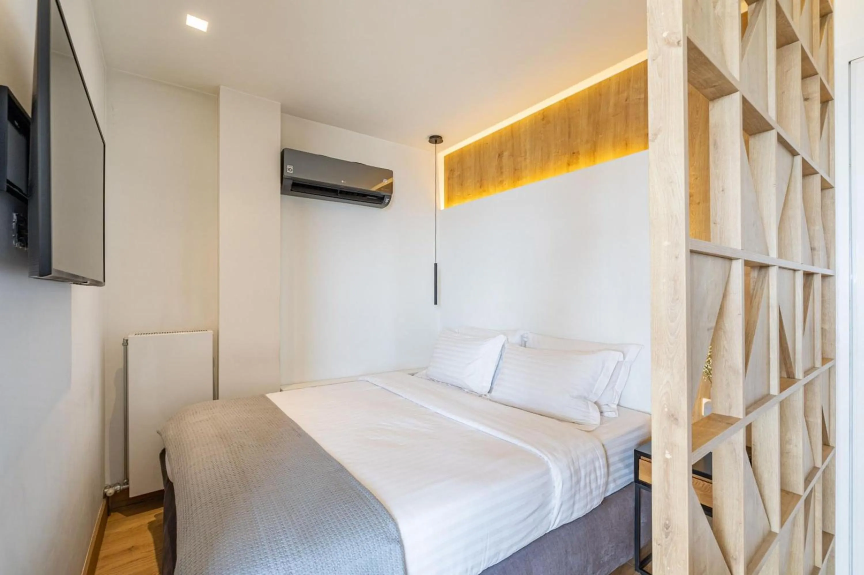 Bed in Earth Boutique Apartments next to Stavros Niarchos