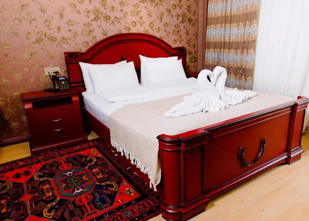 Bed in Royal Antique Boutique Hotel