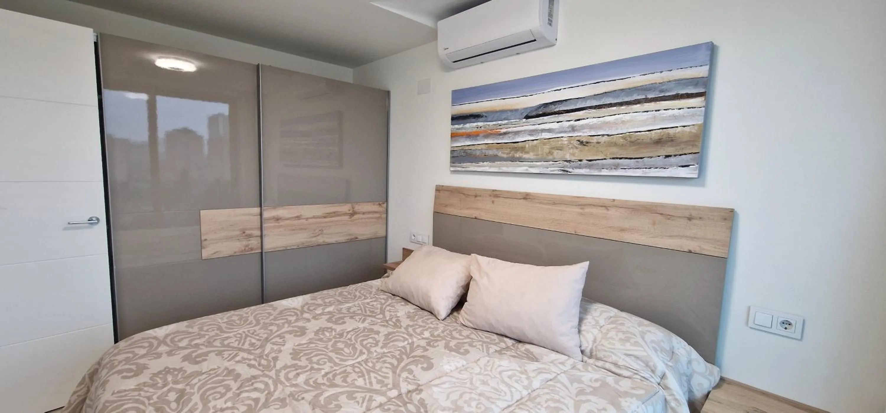 Bed in APARTAMENTOS OASIS DE LA CALA