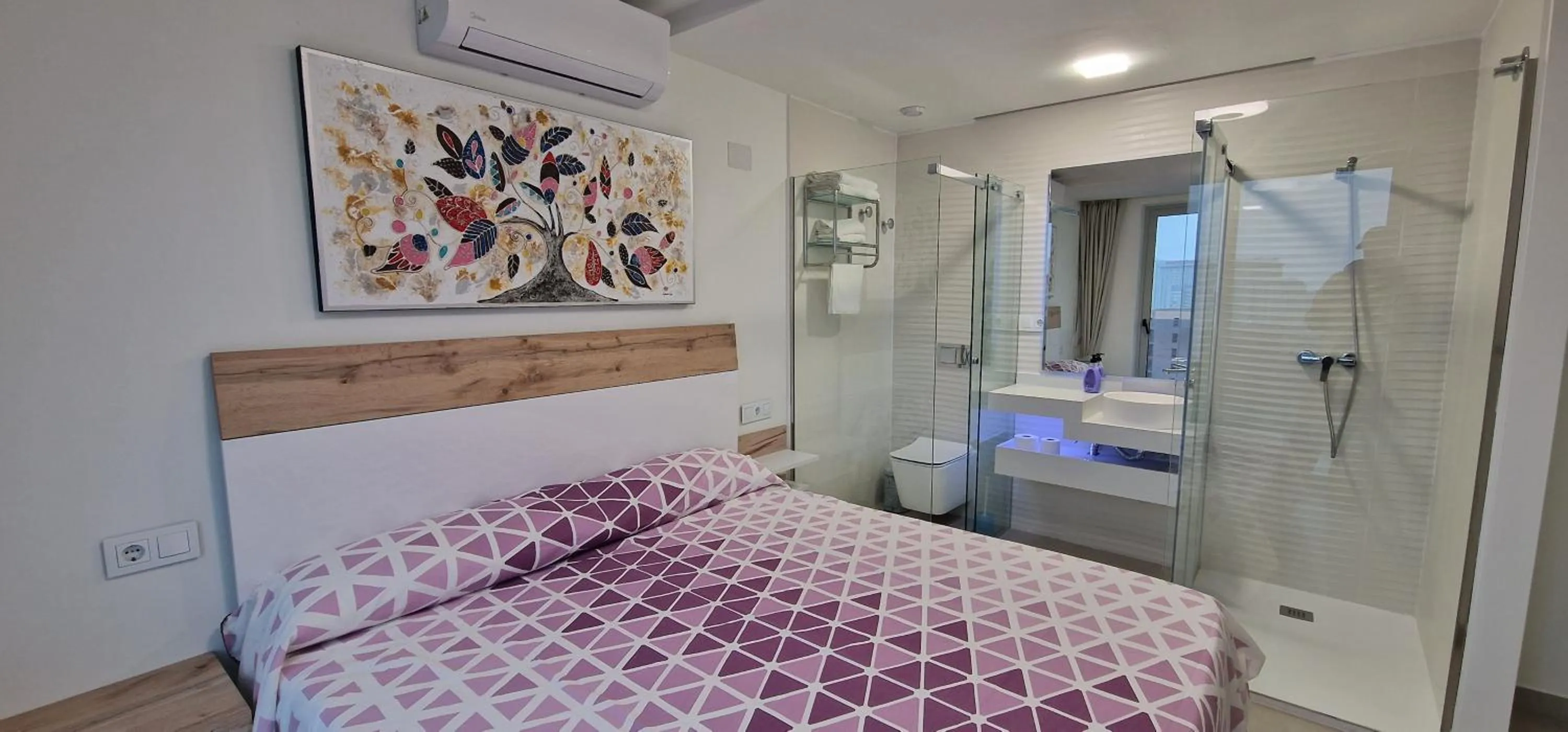 Bed in APARTAMENTOS OASIS DE LA CALA