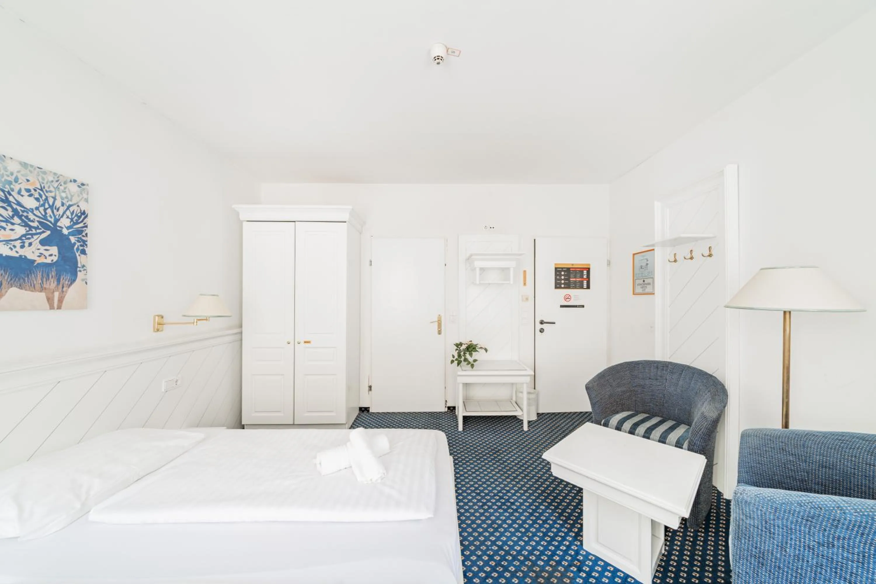 Bed in Self-Check-In Hotel Adlon