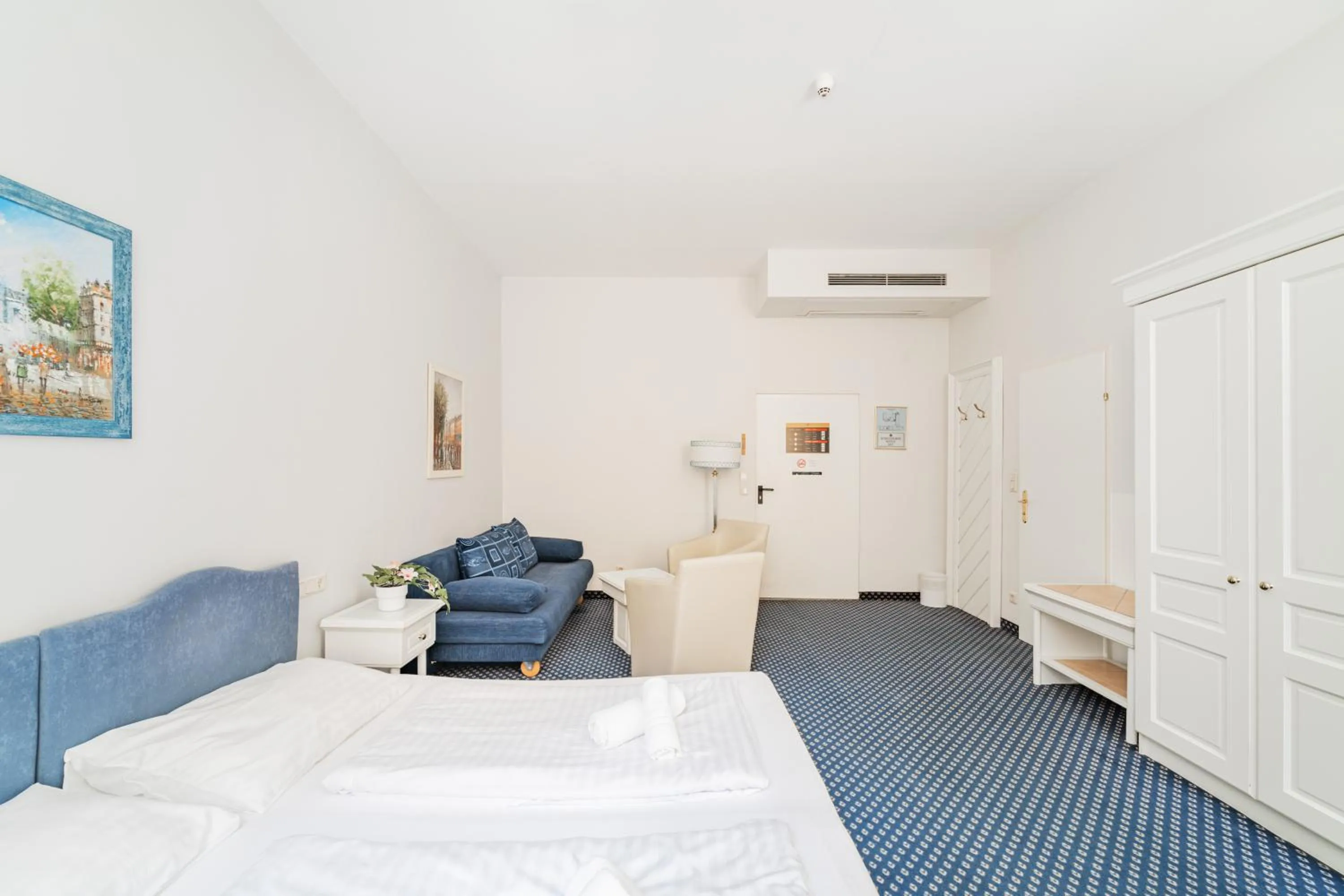 Bed in Self-Check-In Hotel Adlon