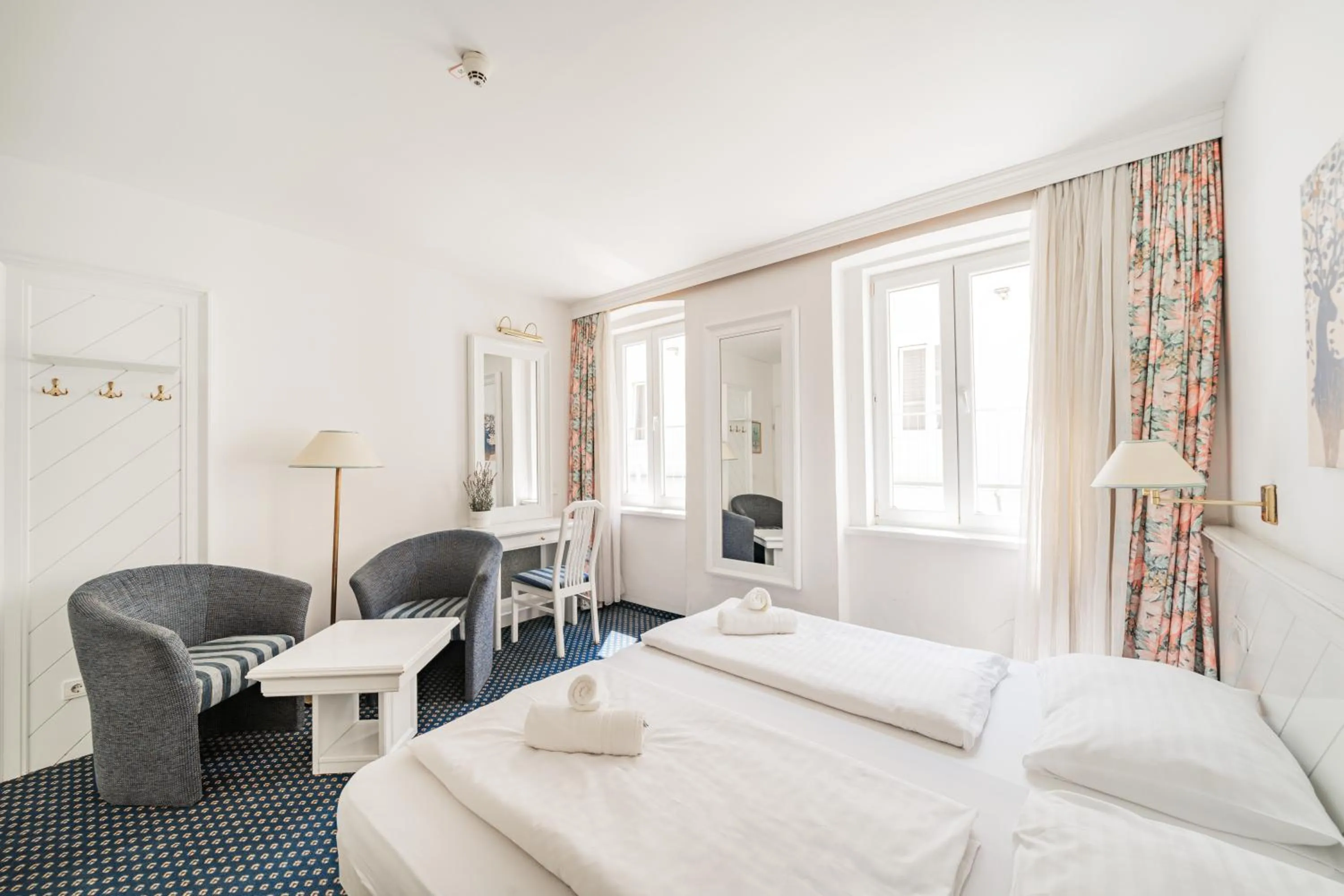 Bed in Self-Check-In Hotel Adlon