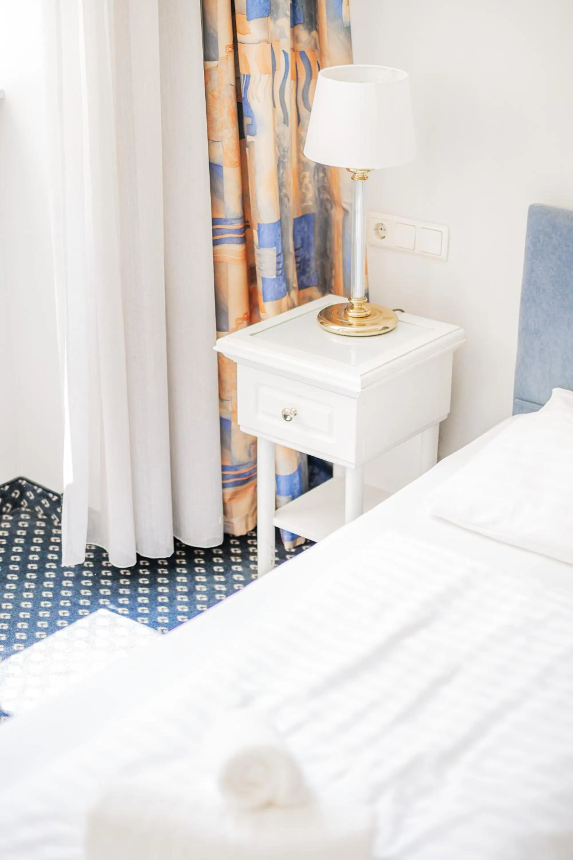 Bed in Self-Check-In Hotel Adlon