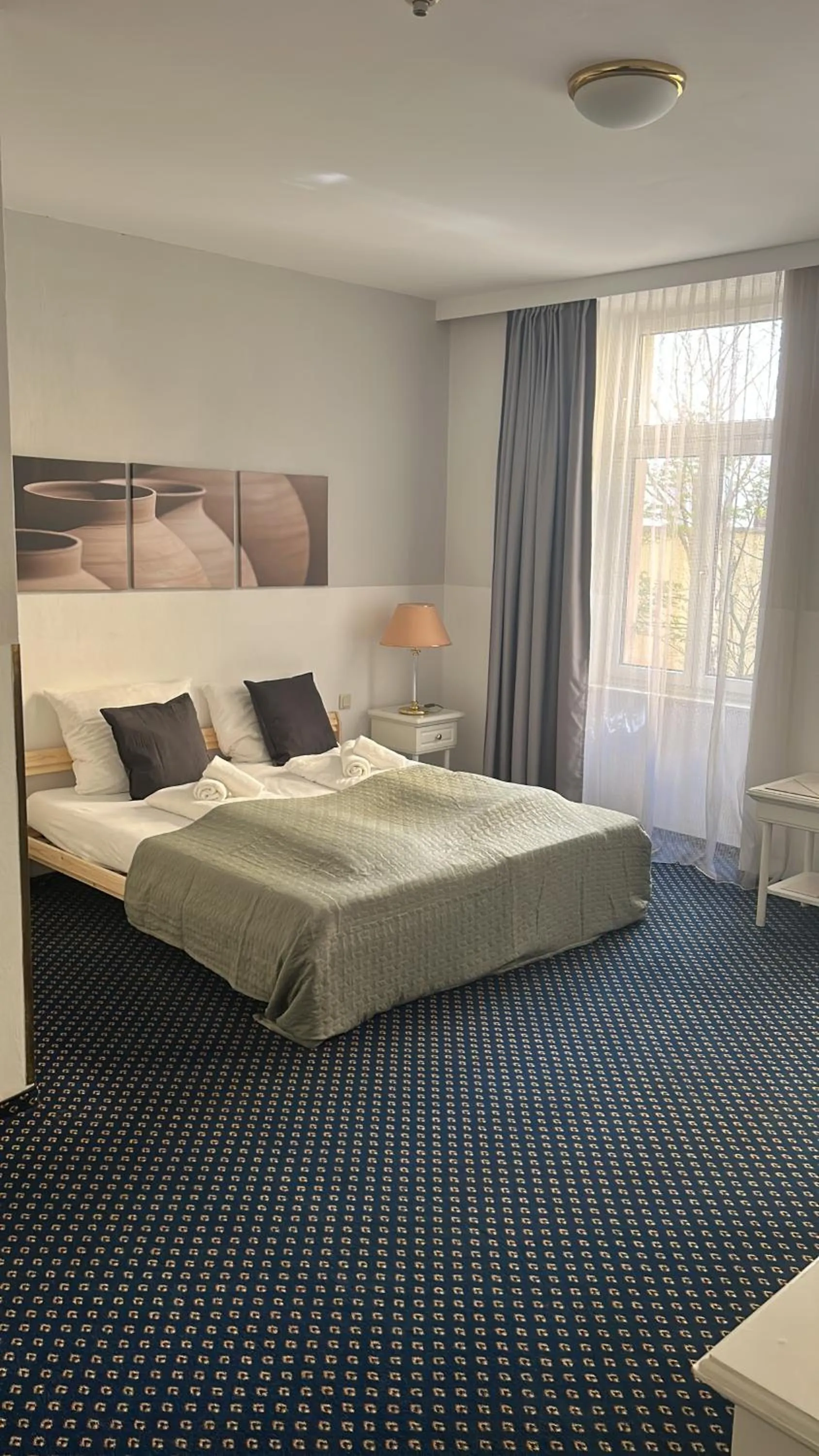 Bed in Self-Check-In Hotel Adlon