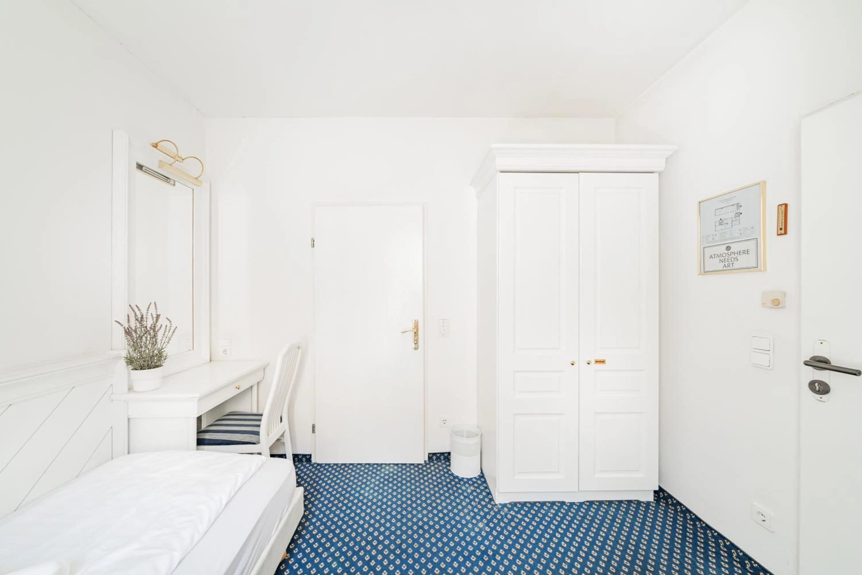 Bed in Self-Check-In Hotel Adlon