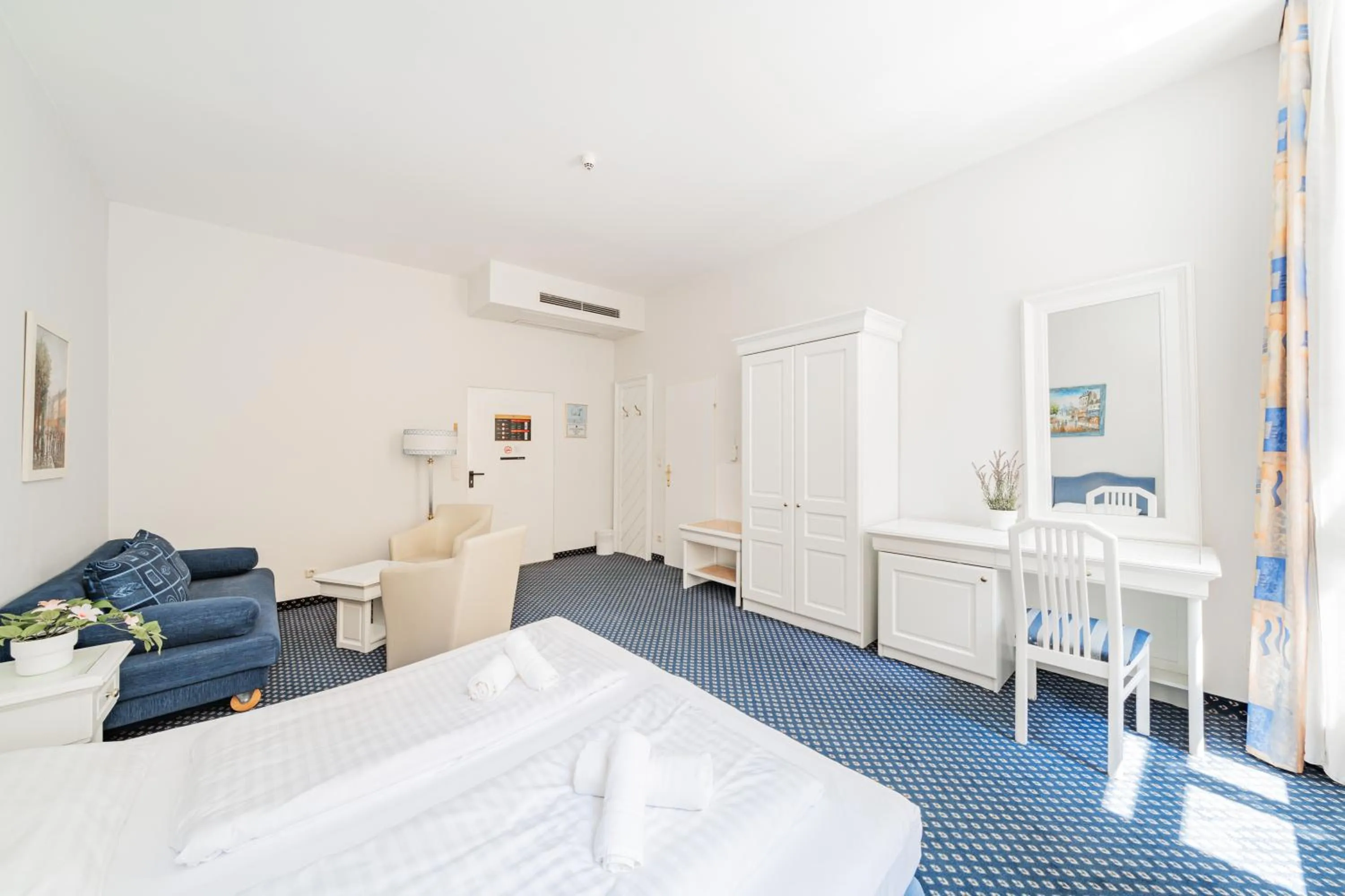 Bed in Self-Check-In Hotel Adlon