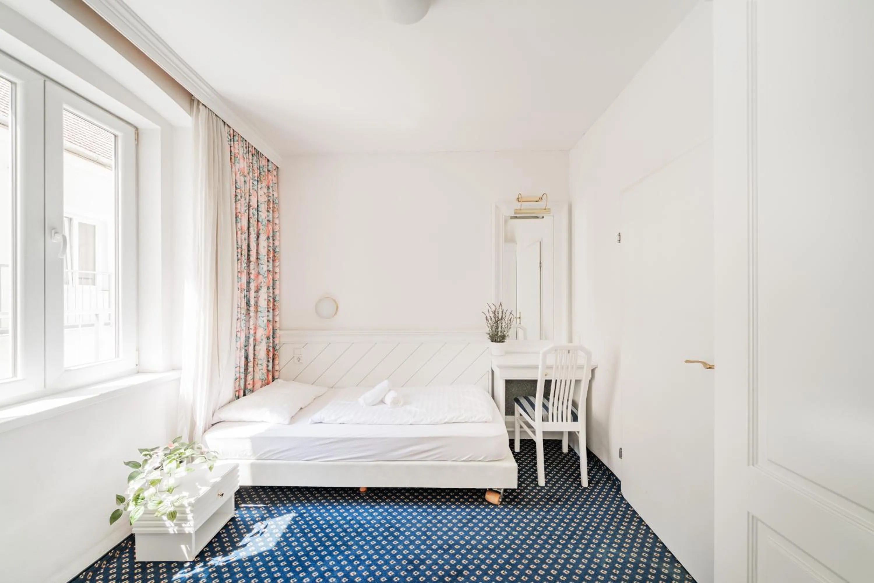 Bed in Self-Check-In Hotel Adlon