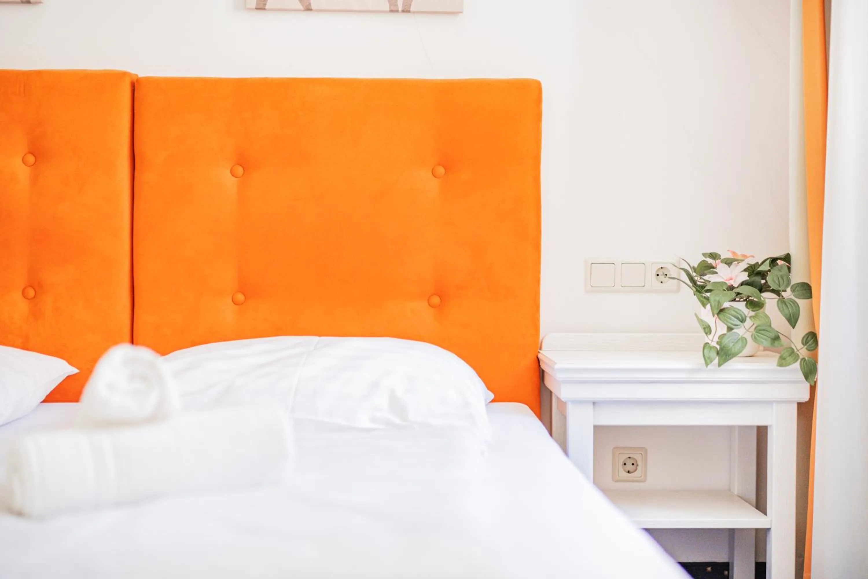 Bed in Self-Check-In Hotel Adlon