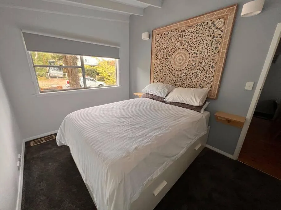 Bed in Sunflower House, a cozy cabin at Lake Wentworth