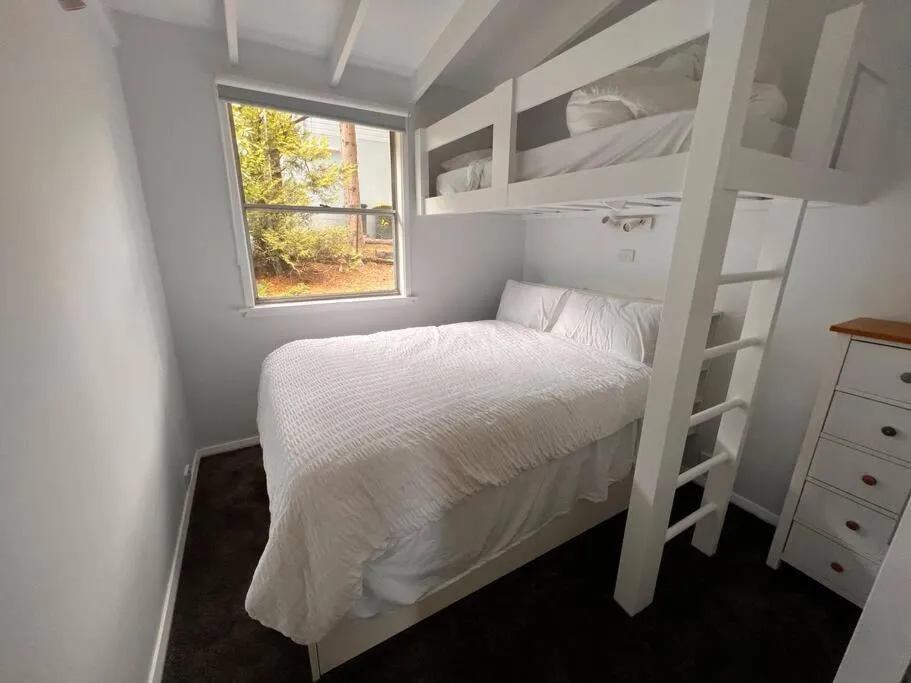 Bed in Sunflower House, a cozy cabin at Lake Wentworth