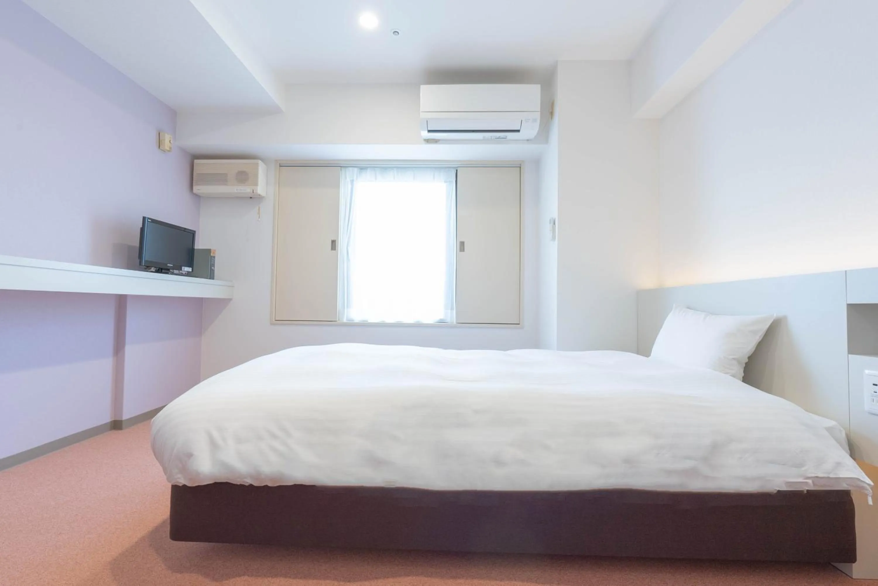 Bed in Hotel Alpha Inn Akita