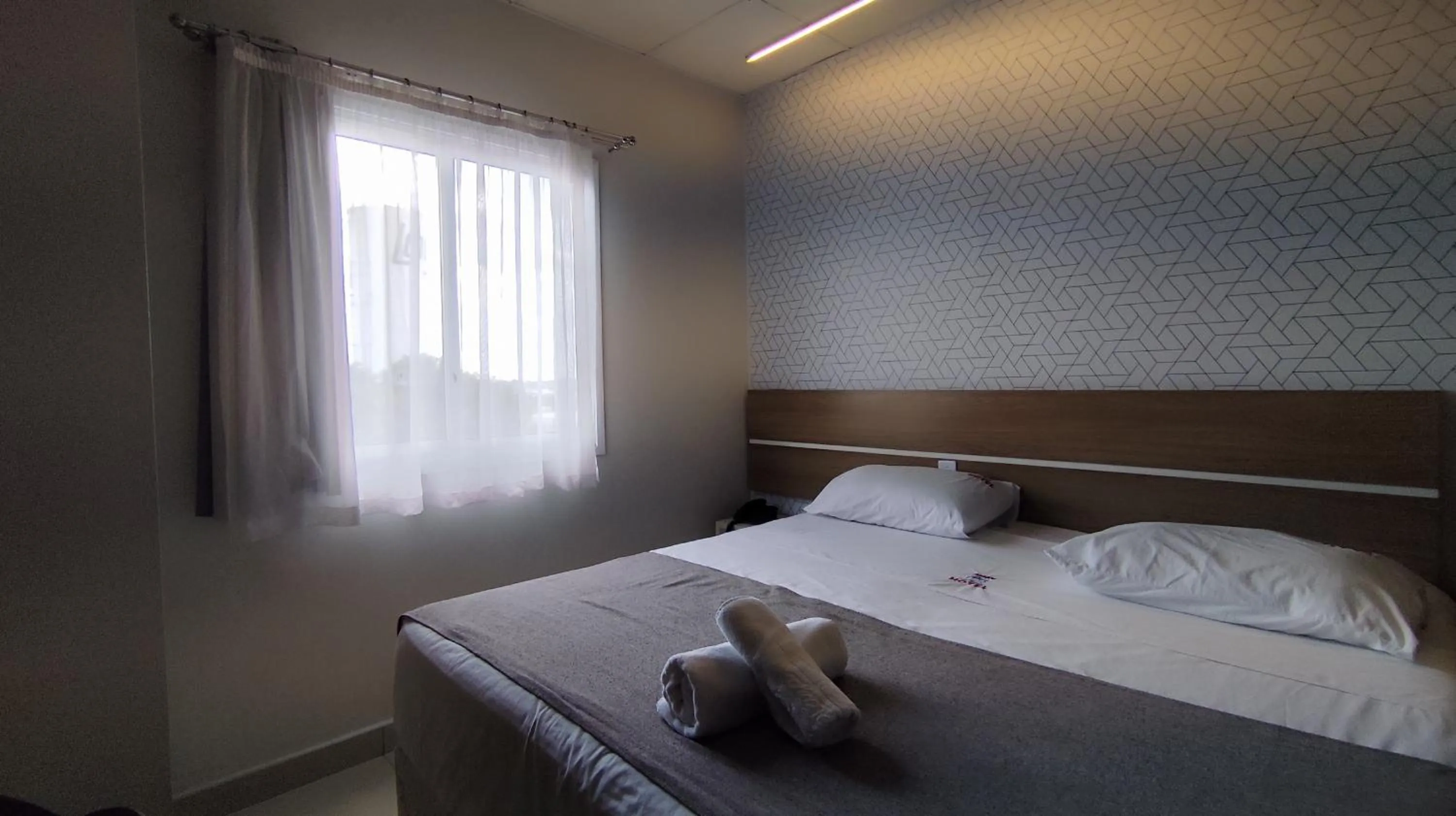 Bed in Assay Plaza Hotel