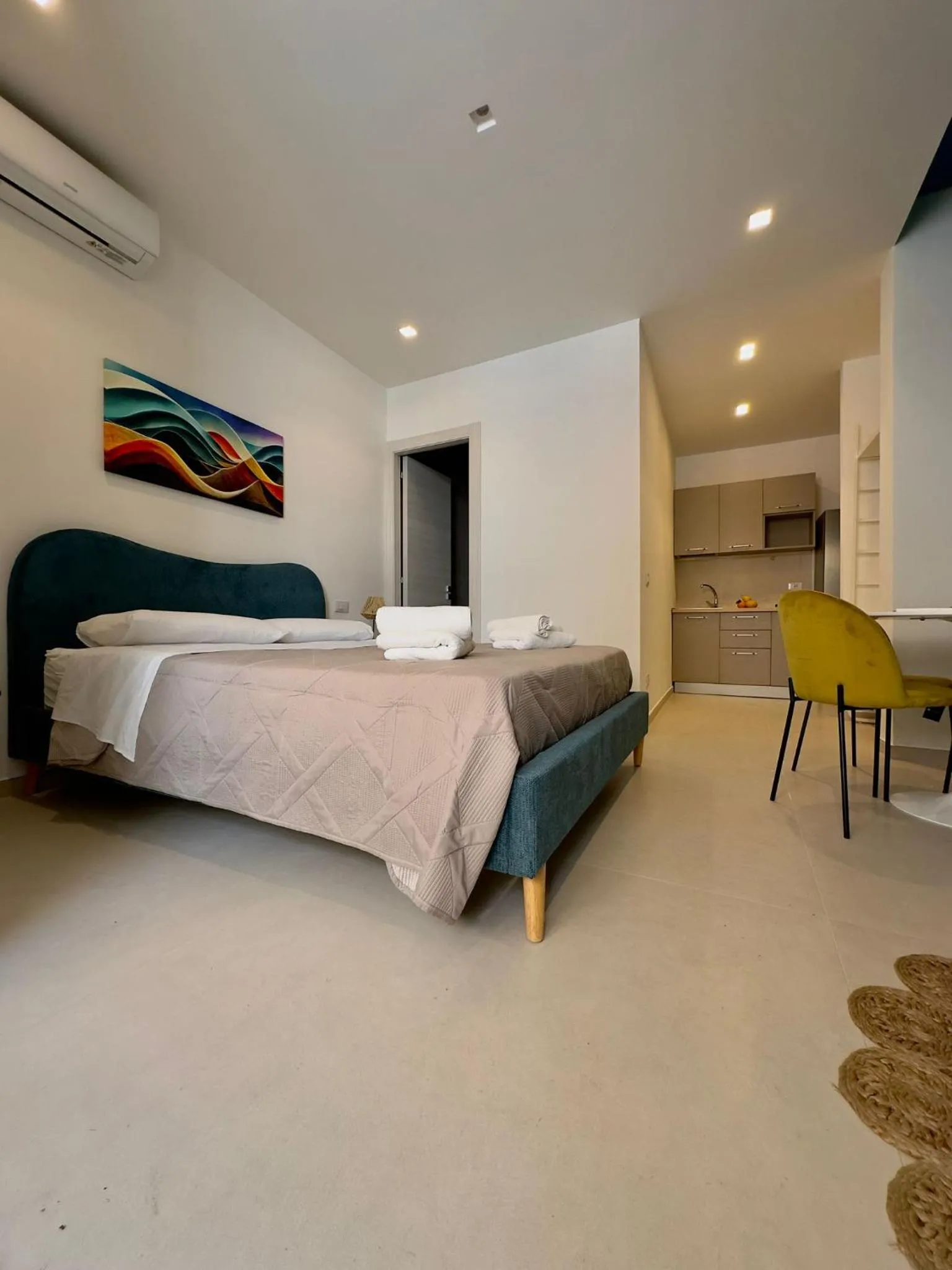Bed in I Faraglioni Comfort Rooms
