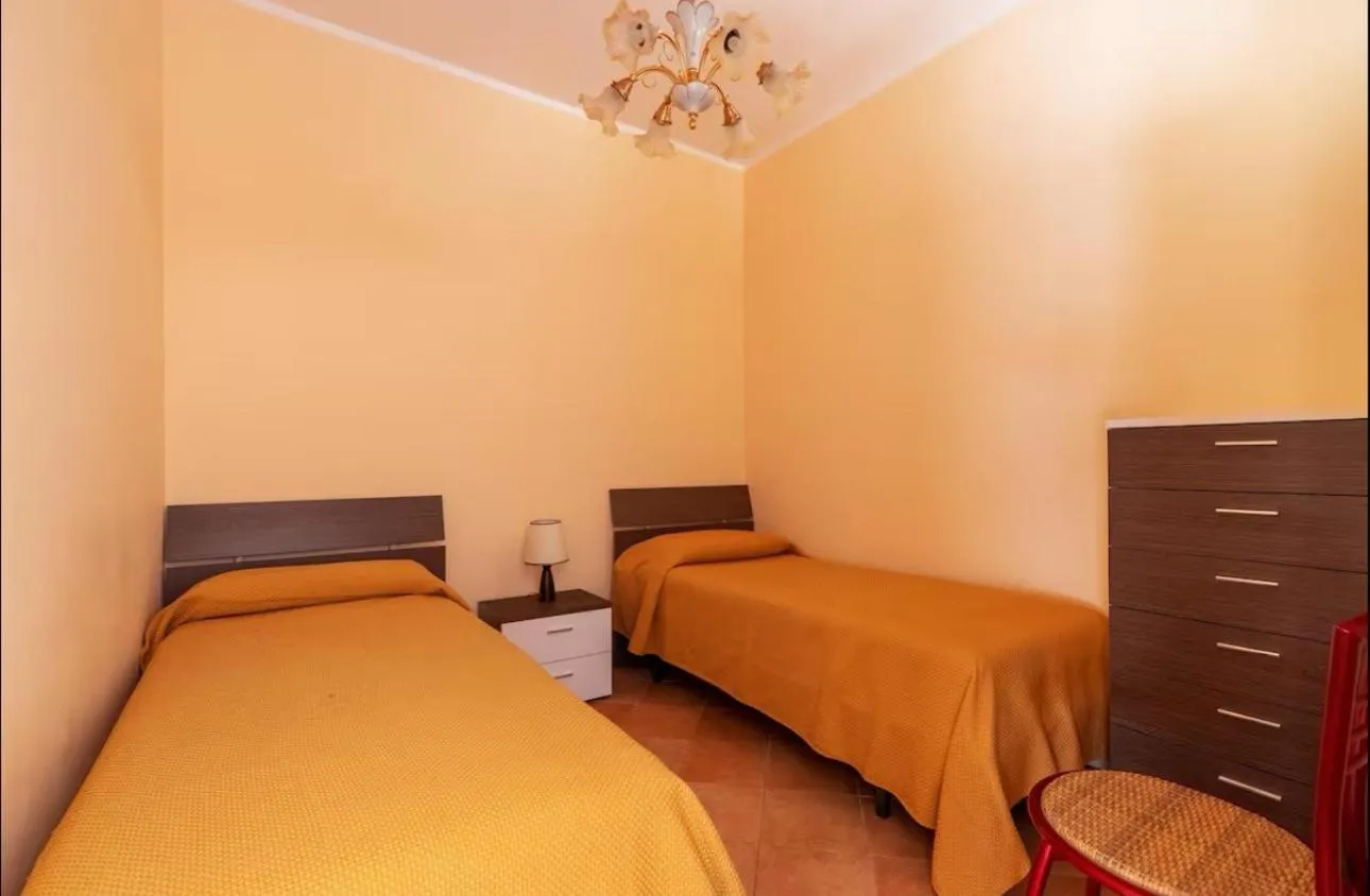 Bed in I Faraglioni Comfort Rooms