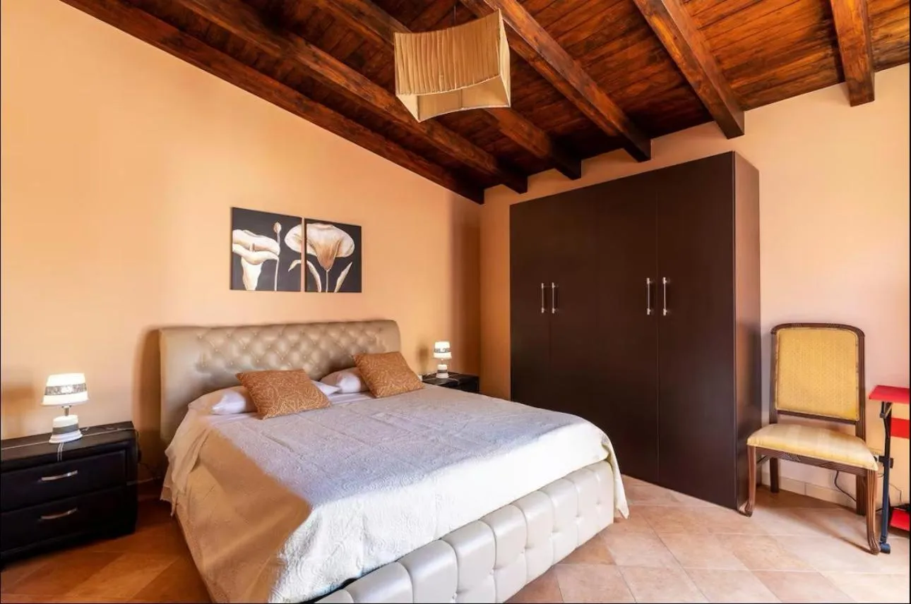 Bed in I Faraglioni Comfort Rooms