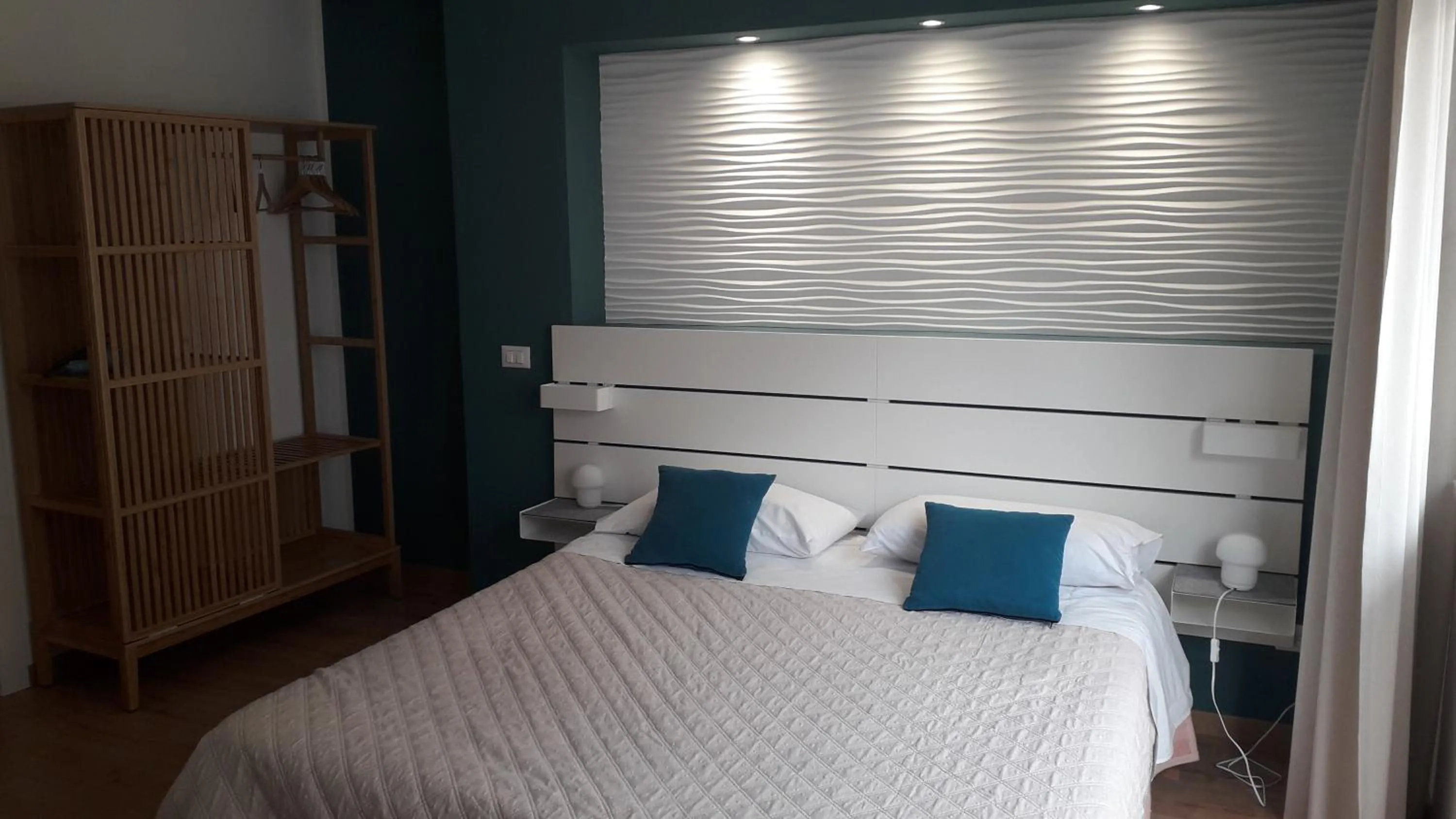 Bed in I Faraglioni Comfort Rooms