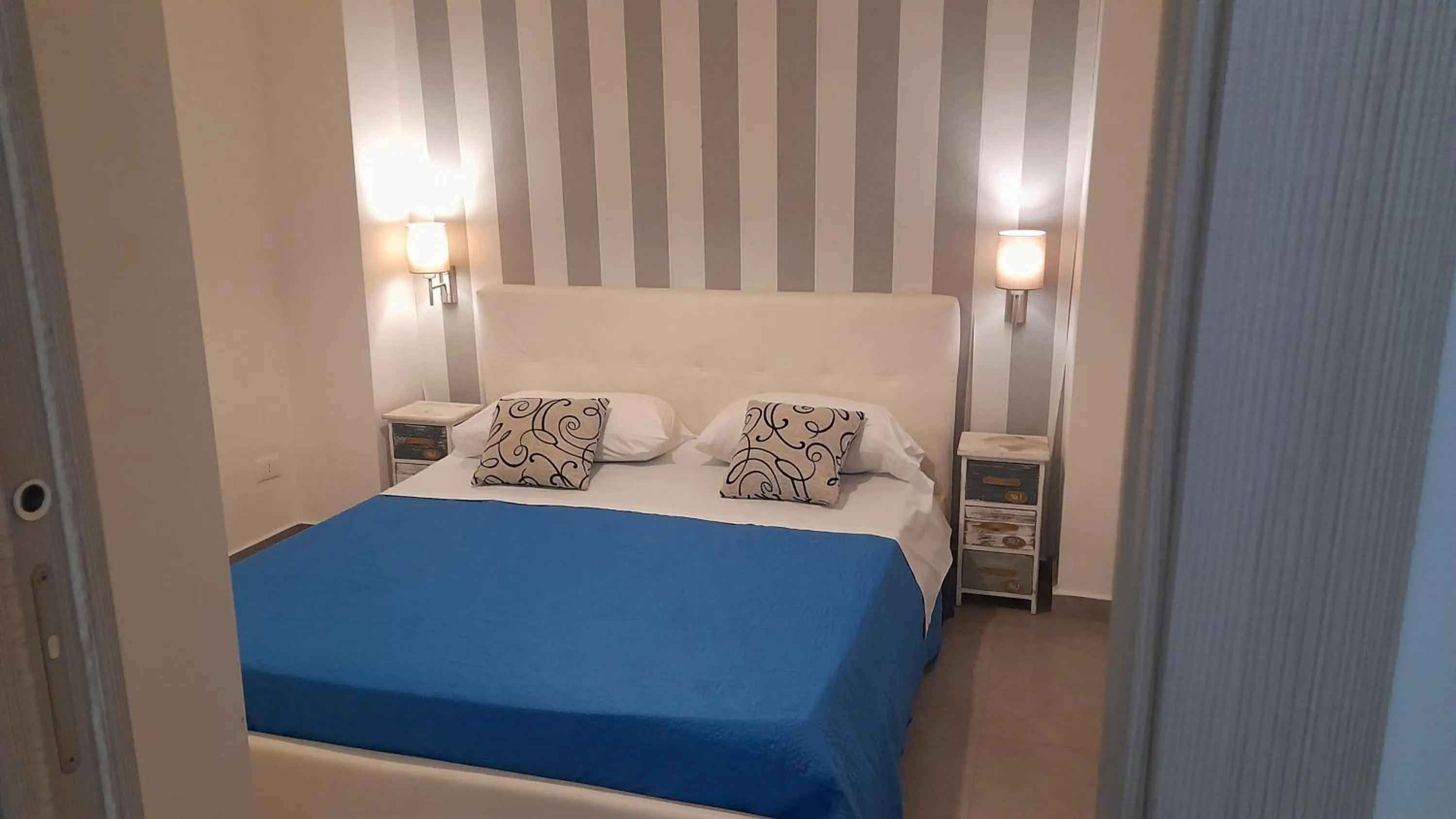 Bed in I Faraglioni Comfort Rooms