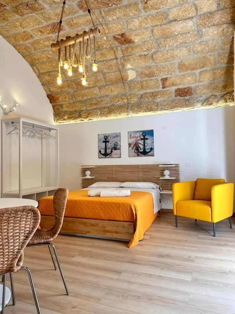 Bed in I Faraglioni Comfort Rooms