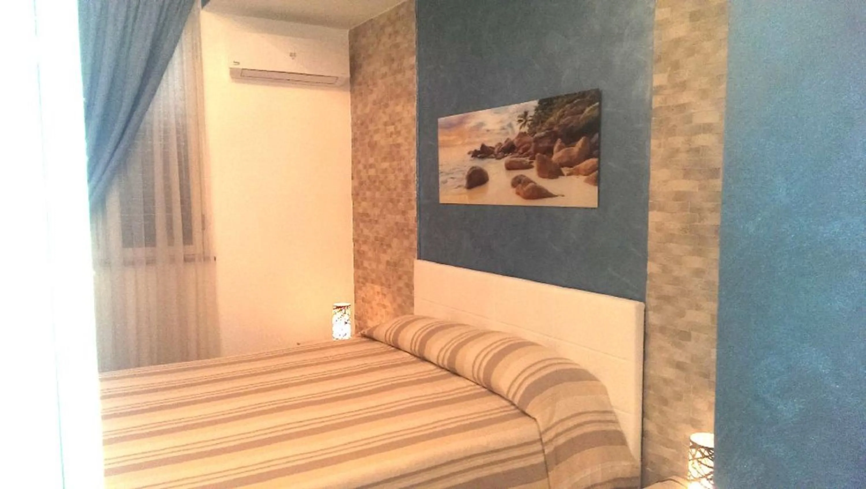 Bed in I Faraglioni Comfort Rooms