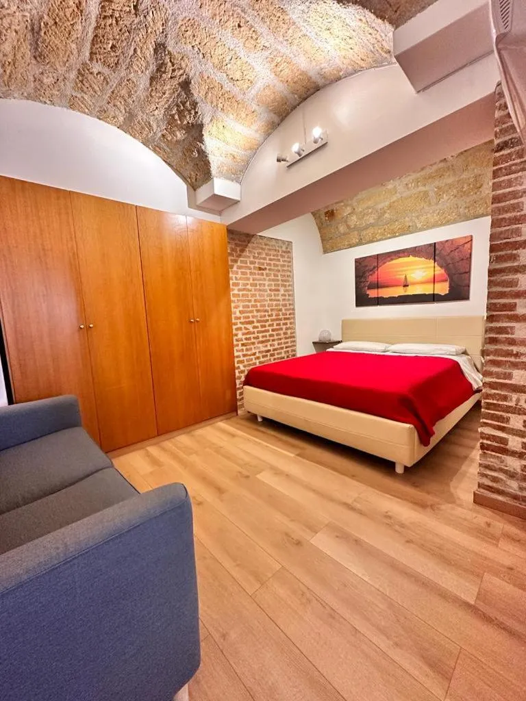 Bed in I Faraglioni Comfort Rooms
