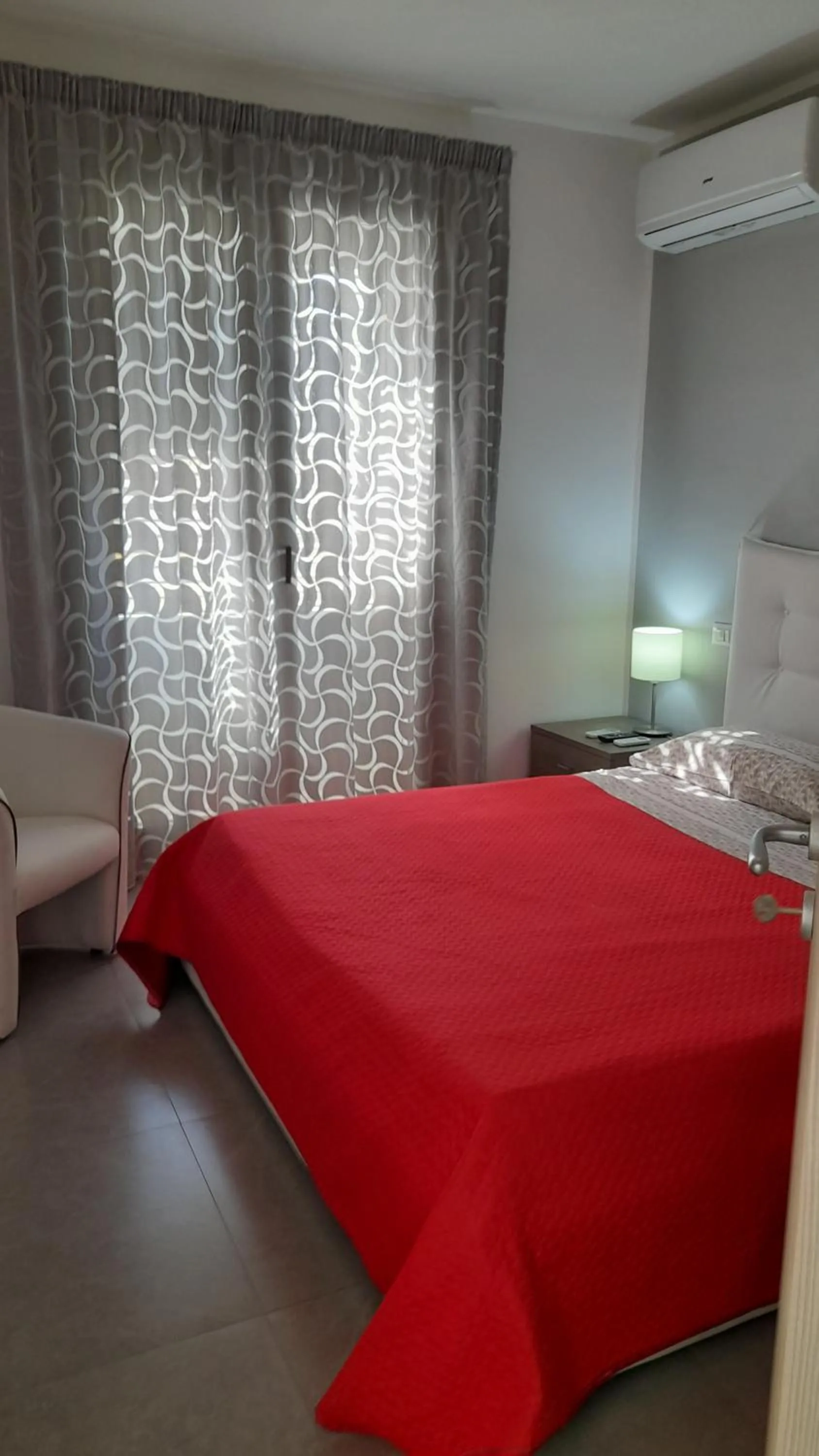 Bed in I Faraglioni Comfort Rooms