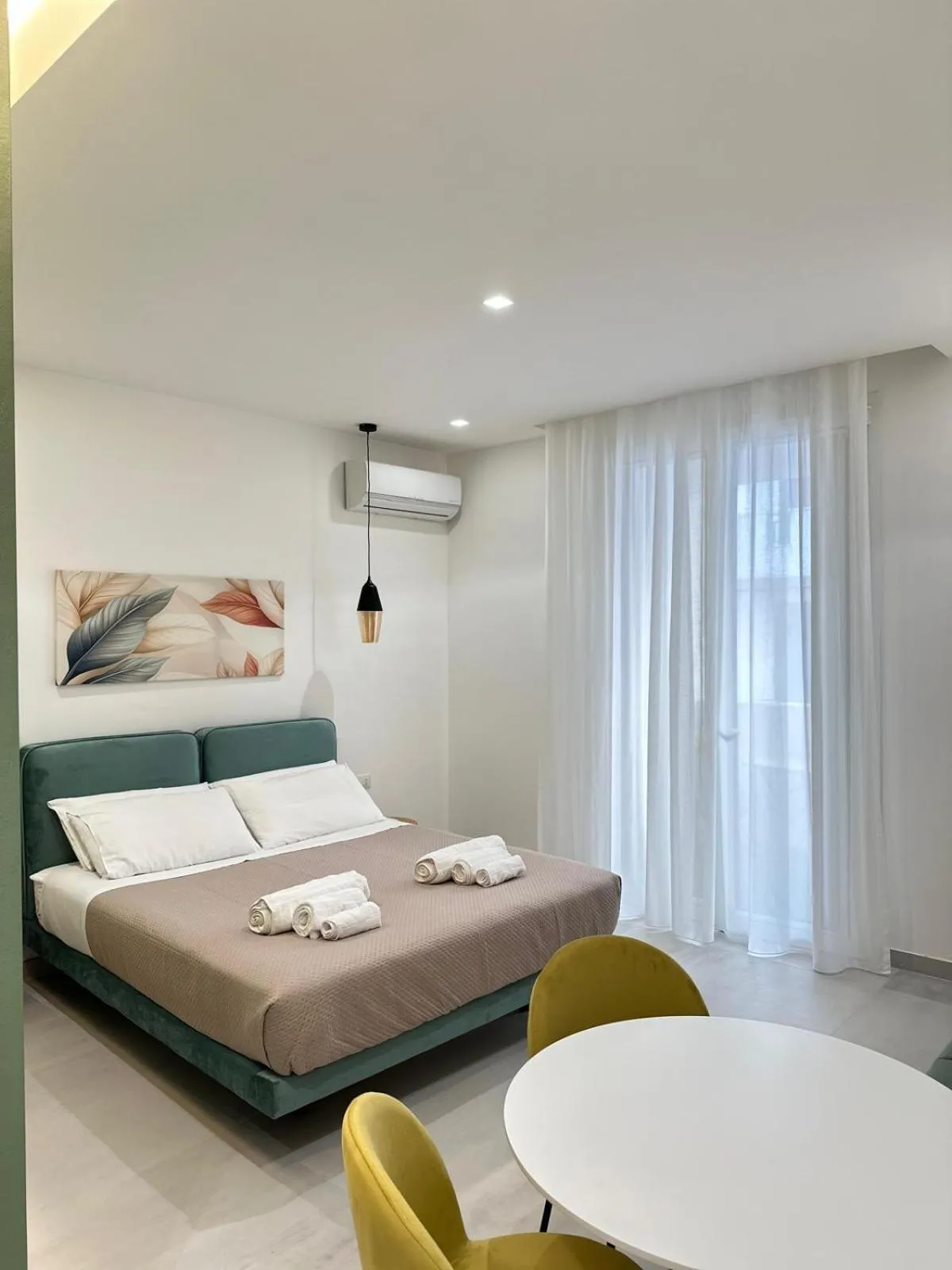 Bed in I Faraglioni Comfort Rooms