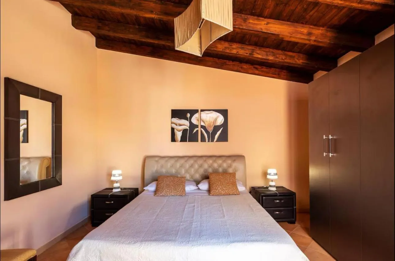 Bed in I Faraglioni Comfort Rooms