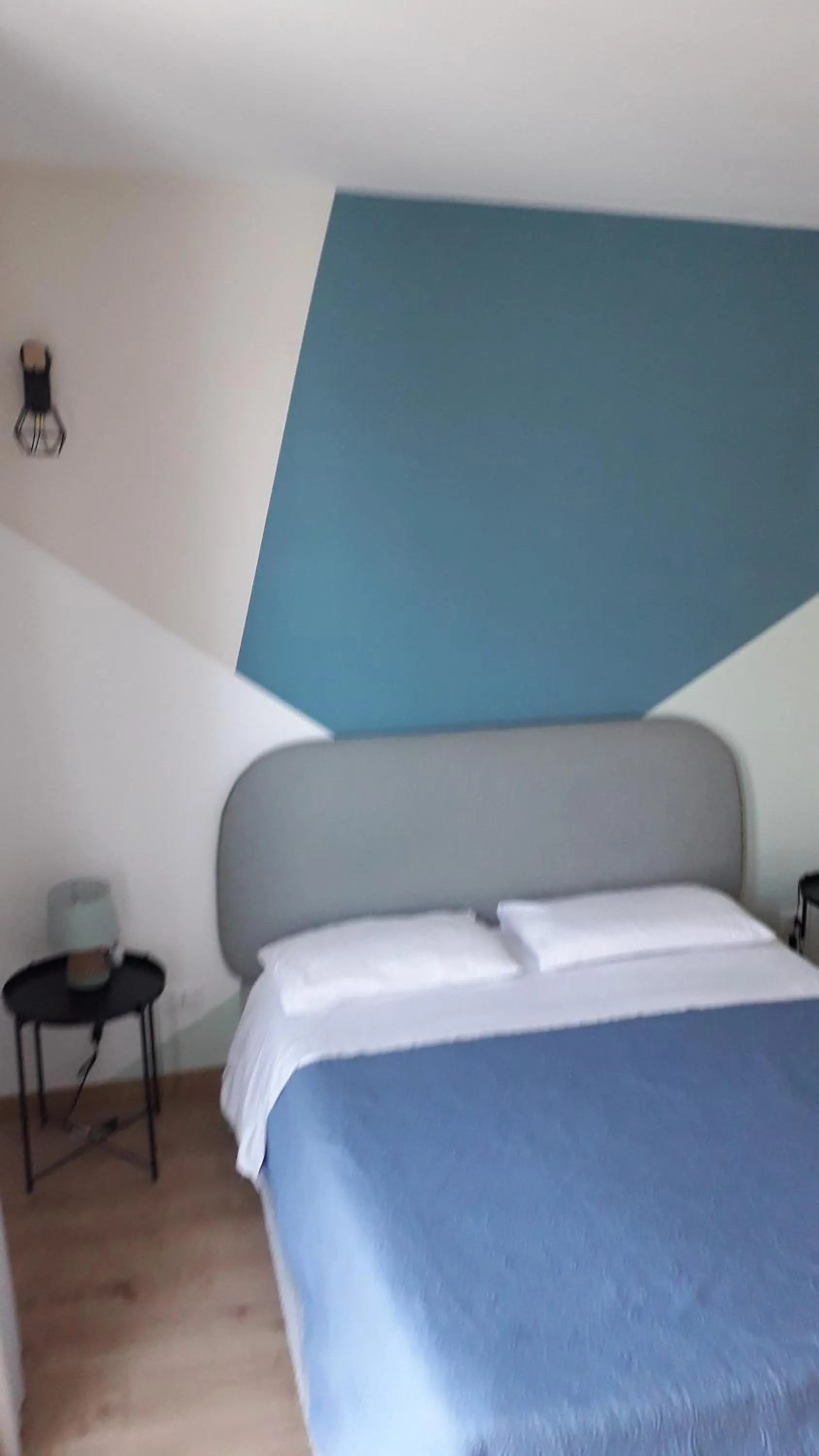 Bed in I Faraglioni Comfort Rooms