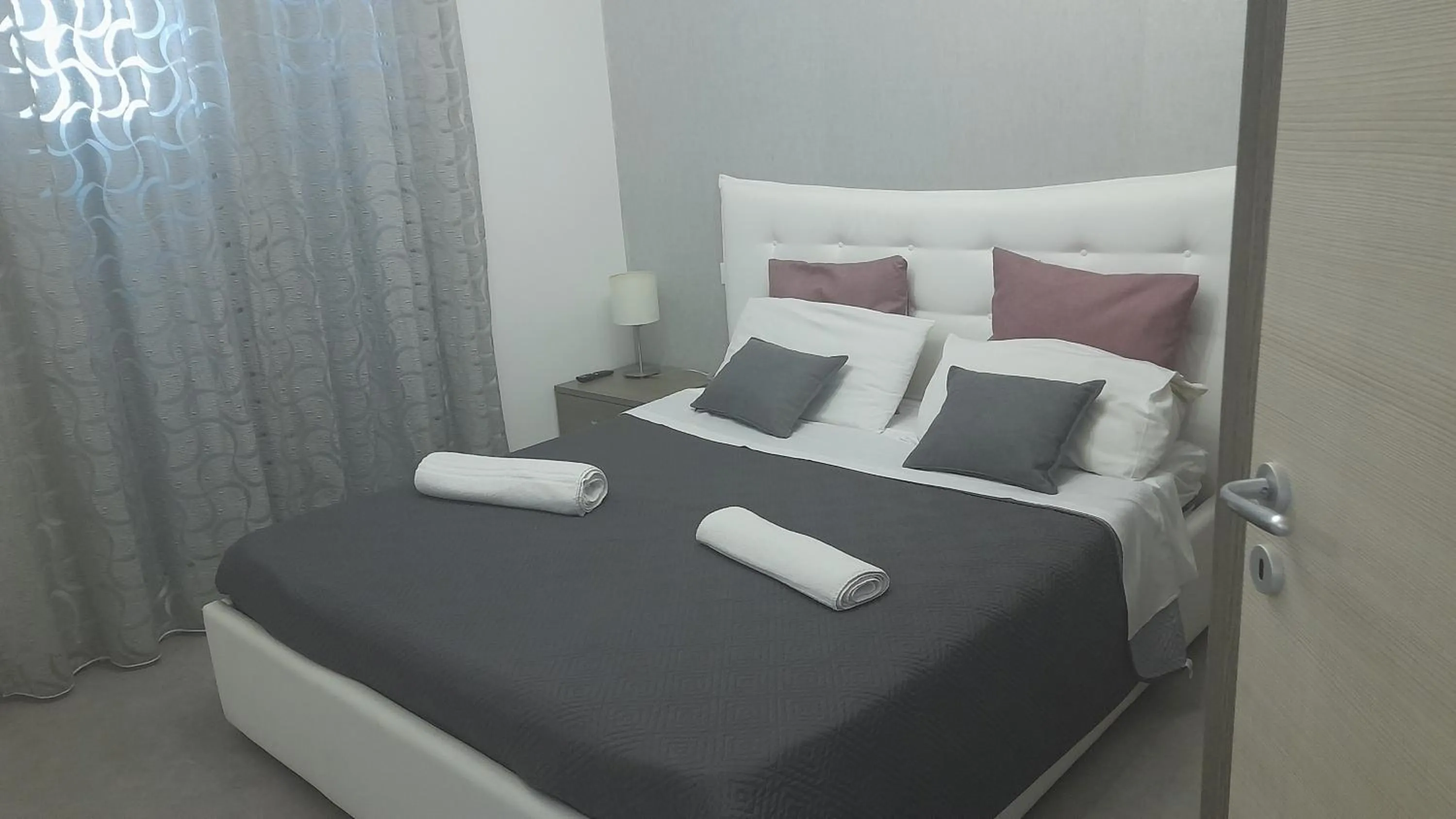 Bed in I Faraglioni Comfort Rooms