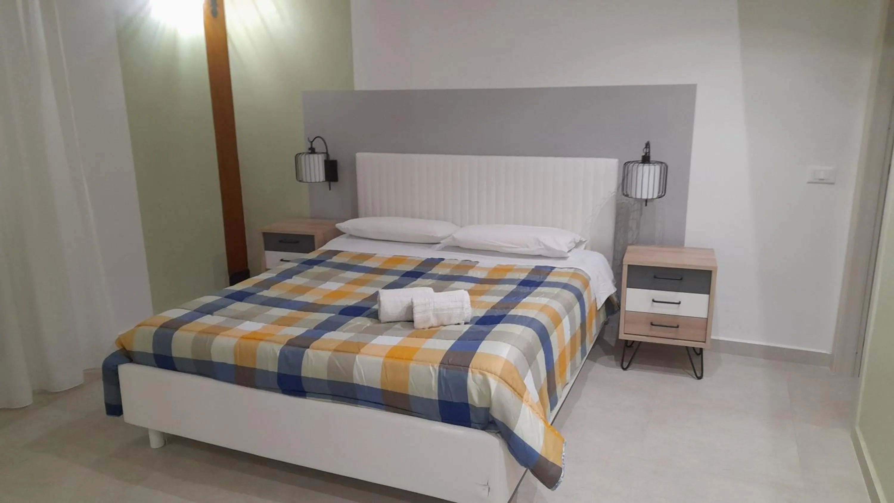 Bed in I Faraglioni Comfort Rooms