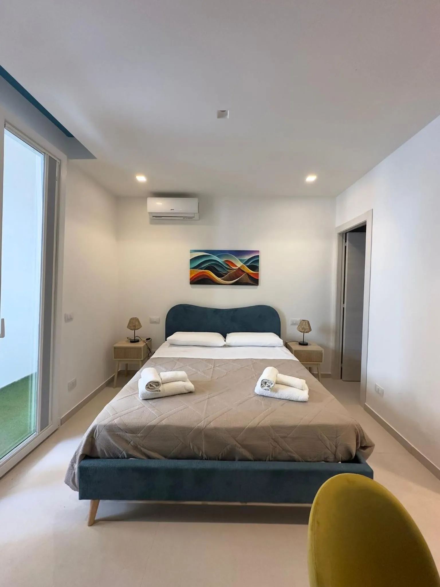 Bed in I Faraglioni Comfort Rooms