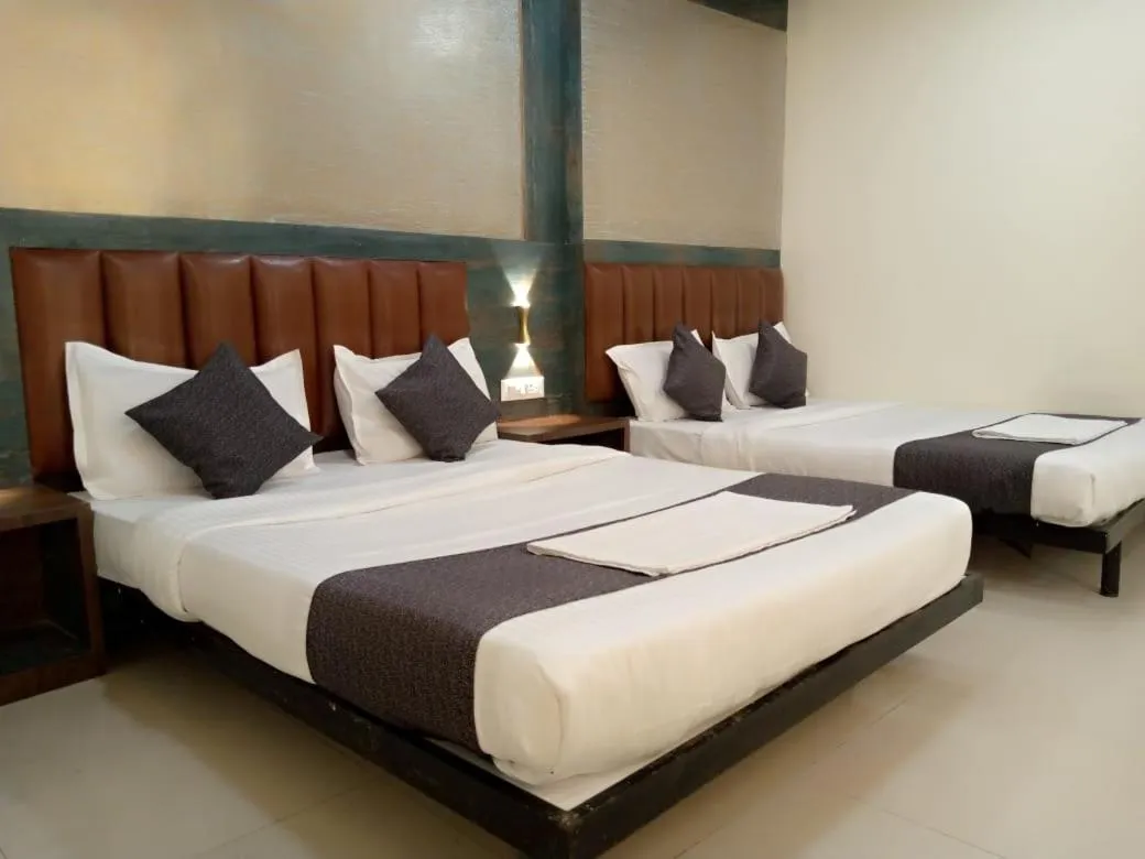 Bed in TRI HOTEL