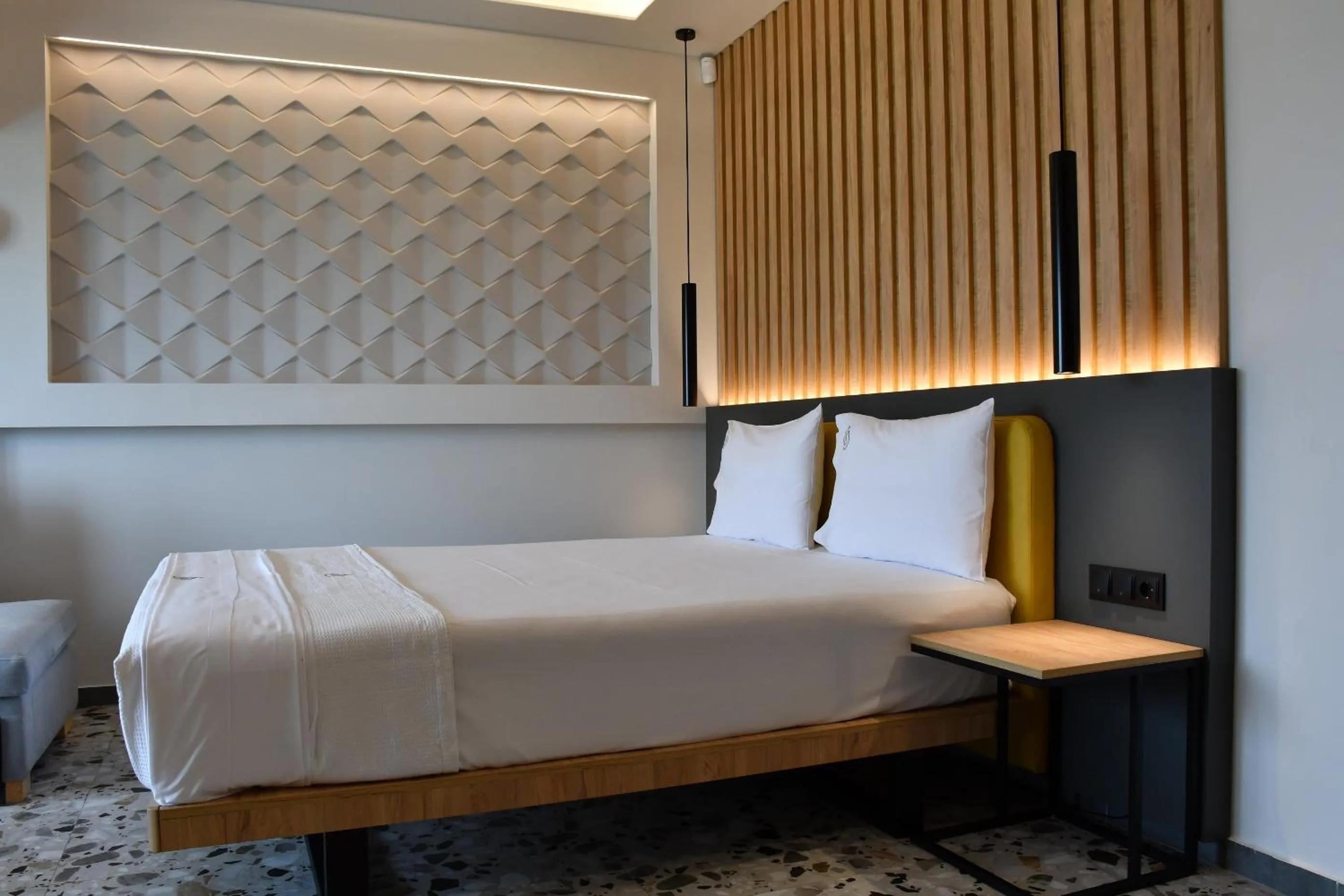 Bed in NERO SEASCAPE SUITES