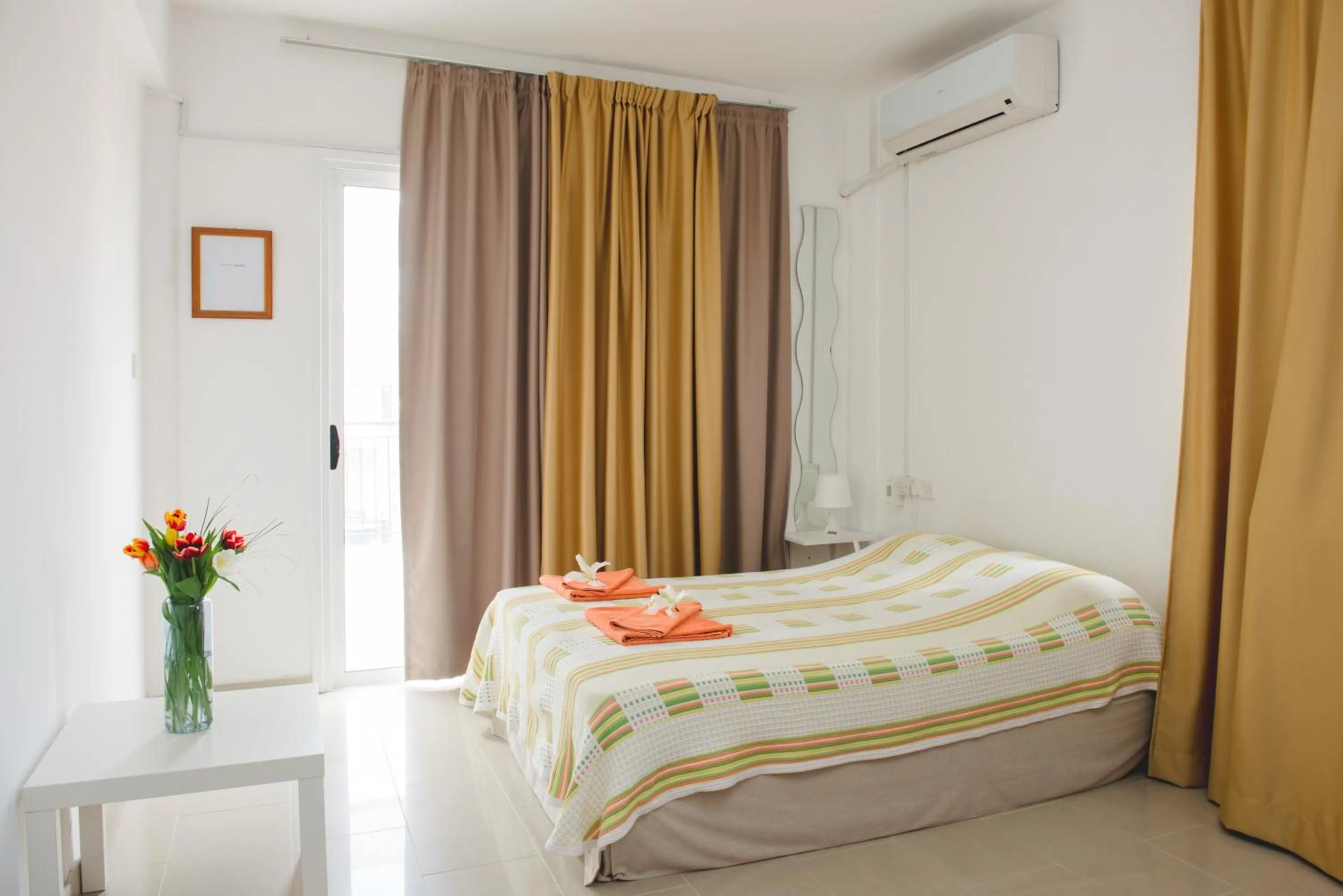 Bed in Valentinos Apartments