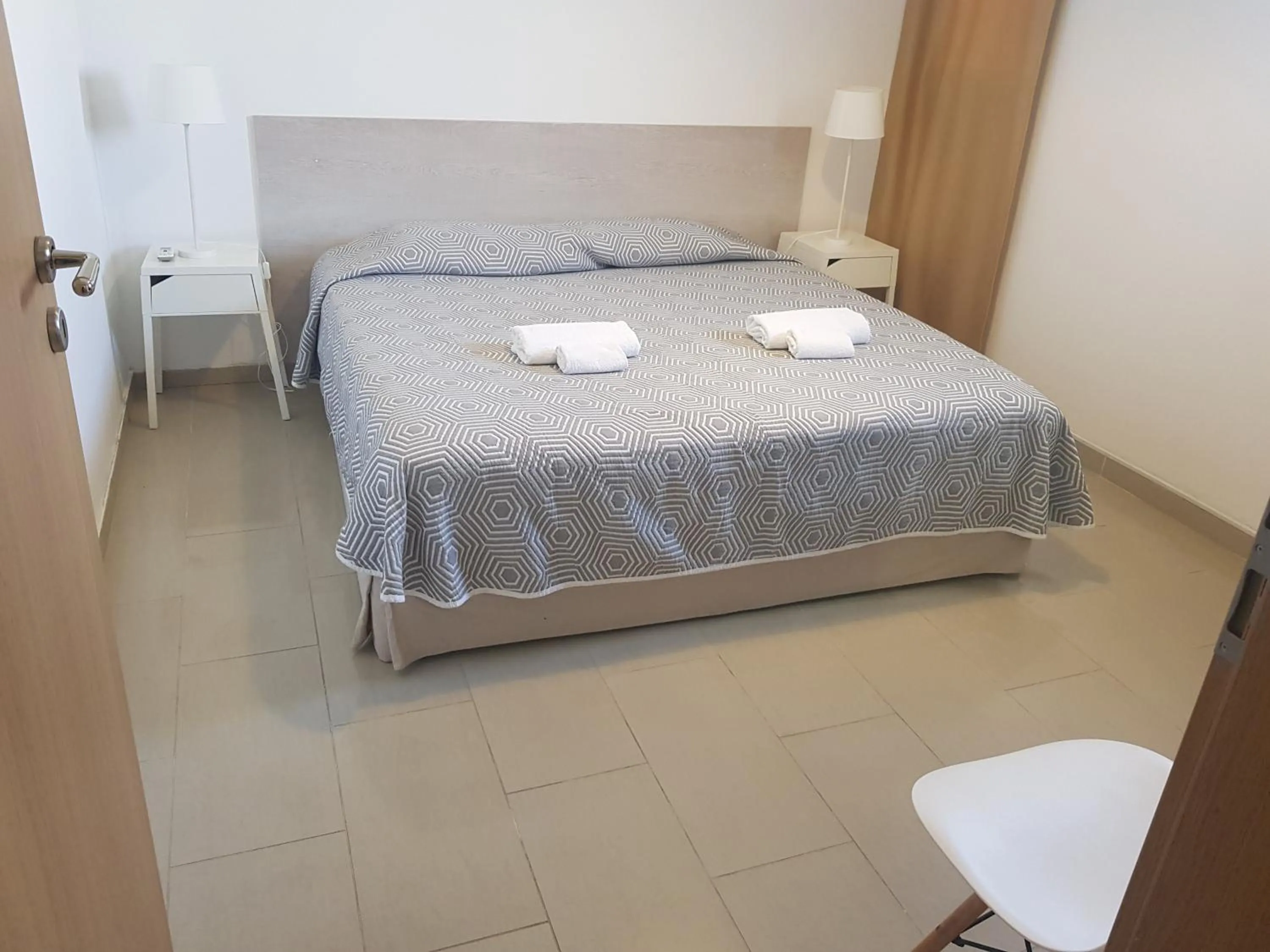 Bed in Valentinos Apartments