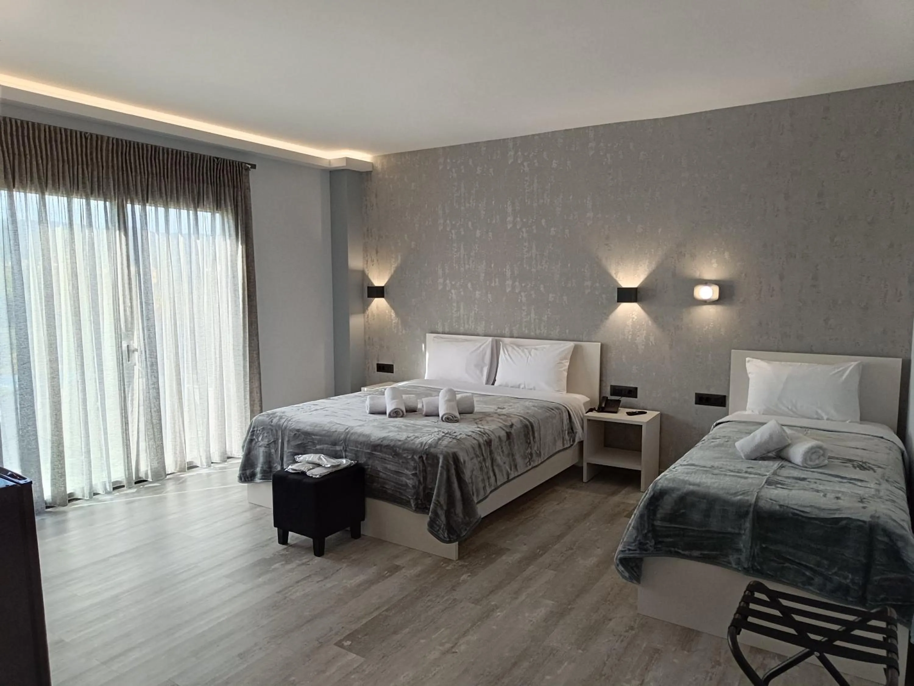 Bed in Oikos 9 Rooms and Suites