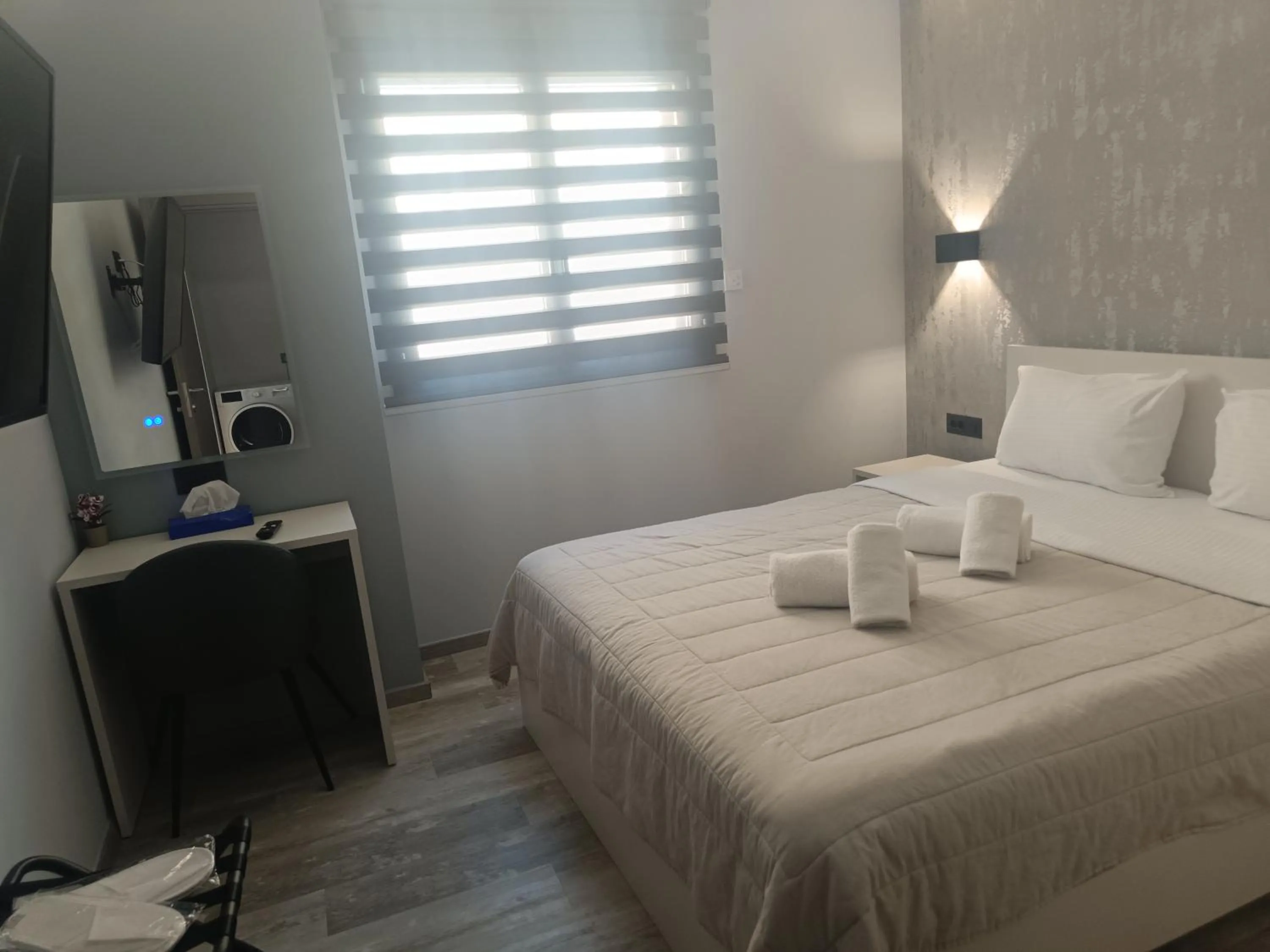 Bed in Oikos 9 Rooms and Suites