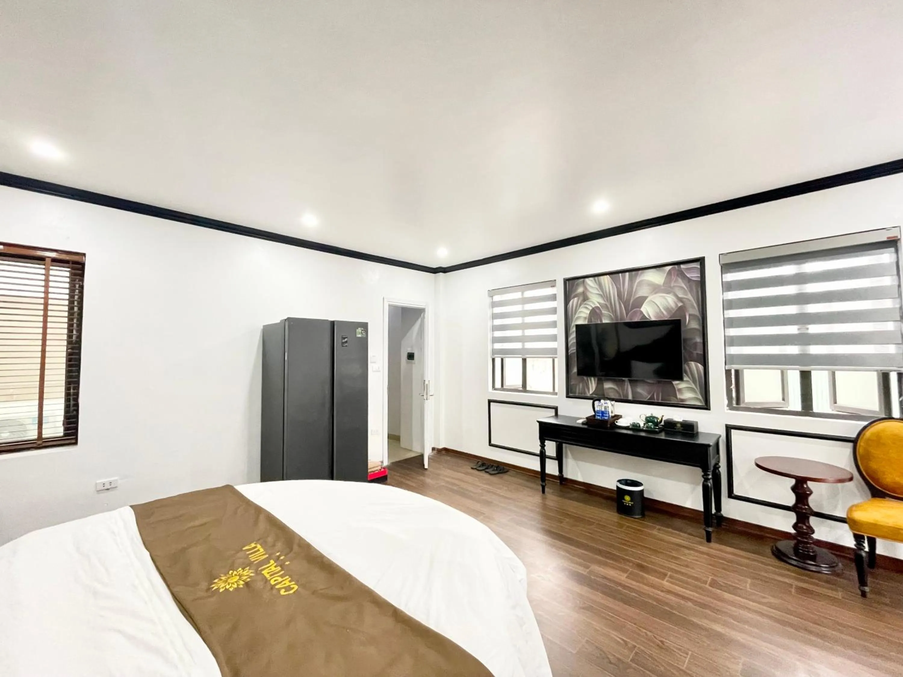 Communal lounge/ TV room, Bed in Capital CauGiay Hotel