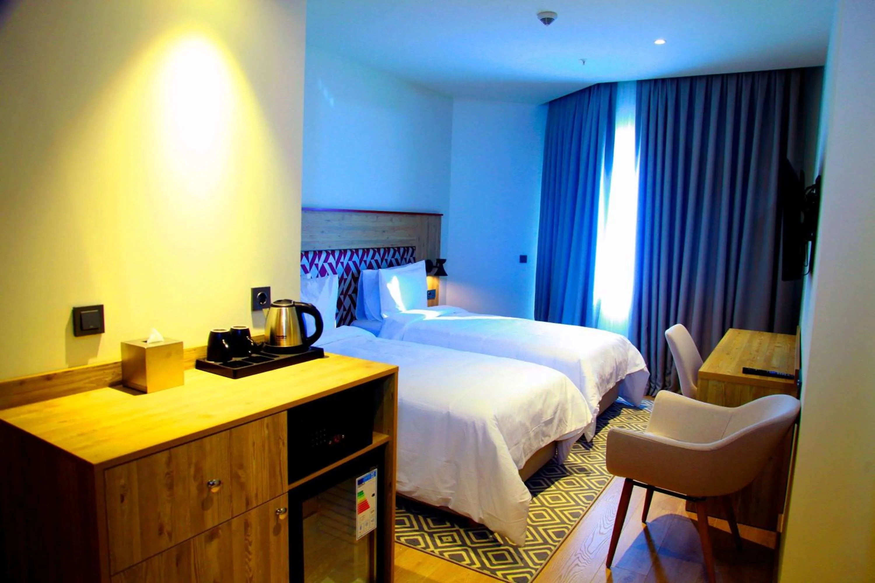 Bed in Ramada Encore by Wyndham Zomin