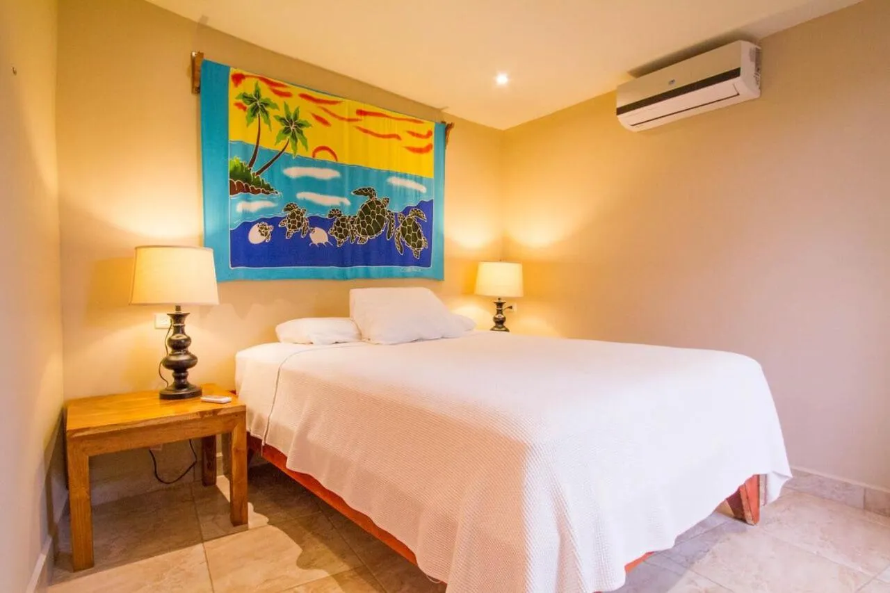 Bed in Tamarindo Village Hotel