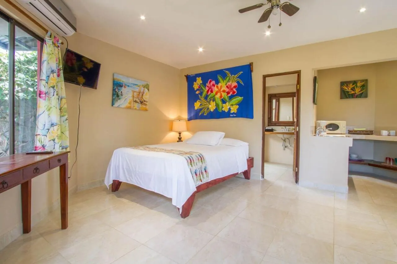 Bed in Tamarindo Village Hotel