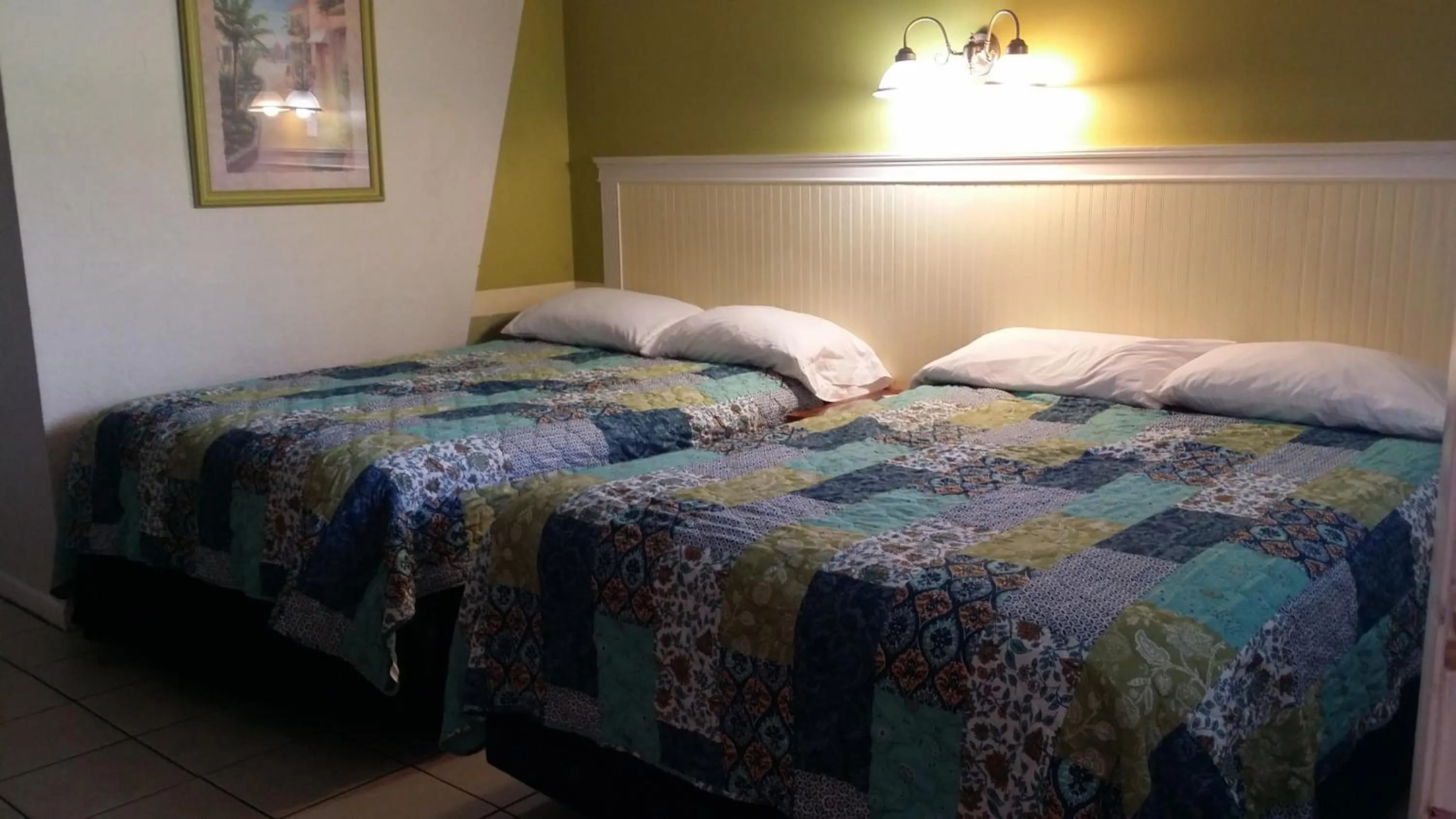 Bed in Palm Breeze Hotel