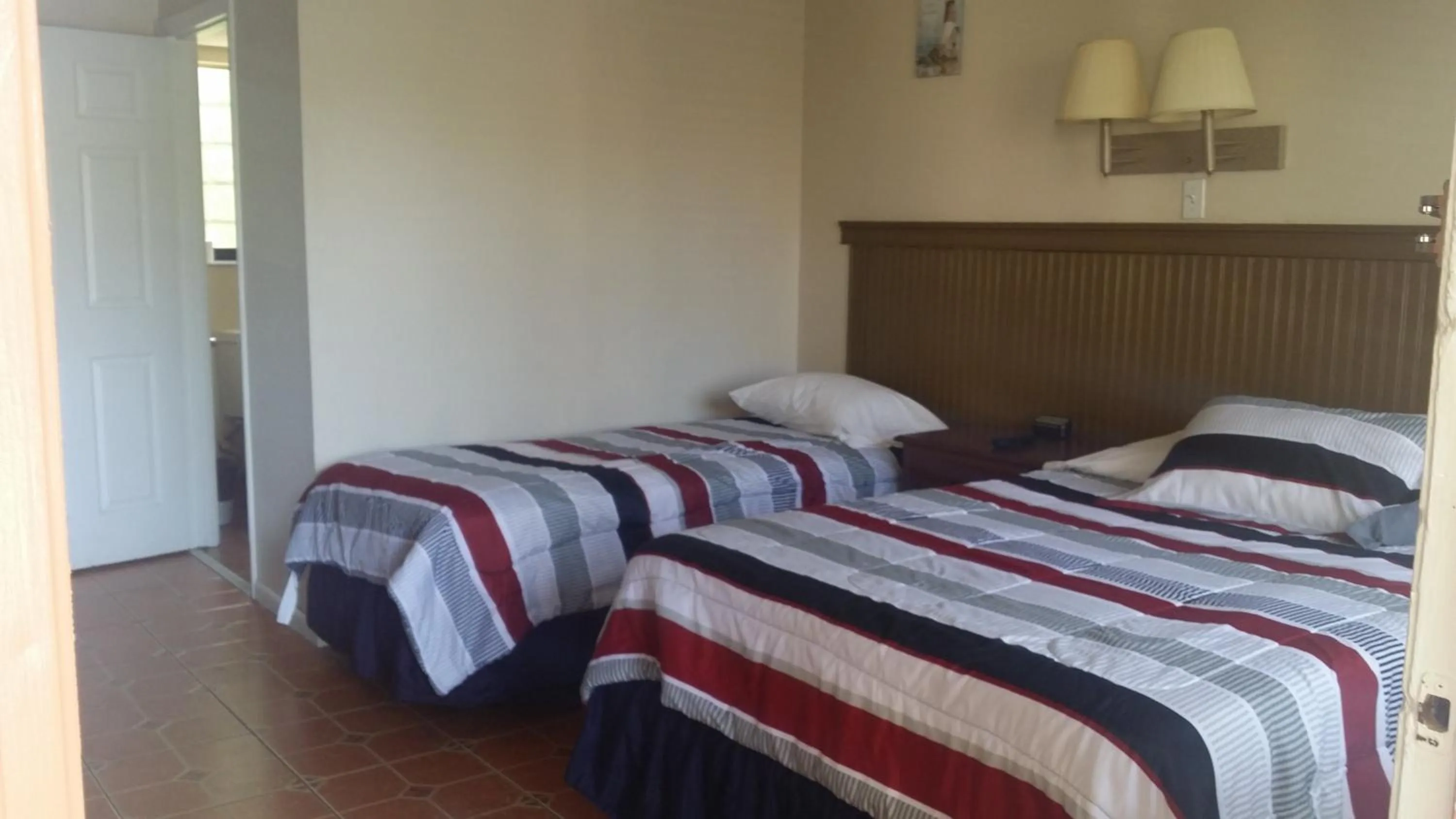 Bed in Palm Breeze Hotel