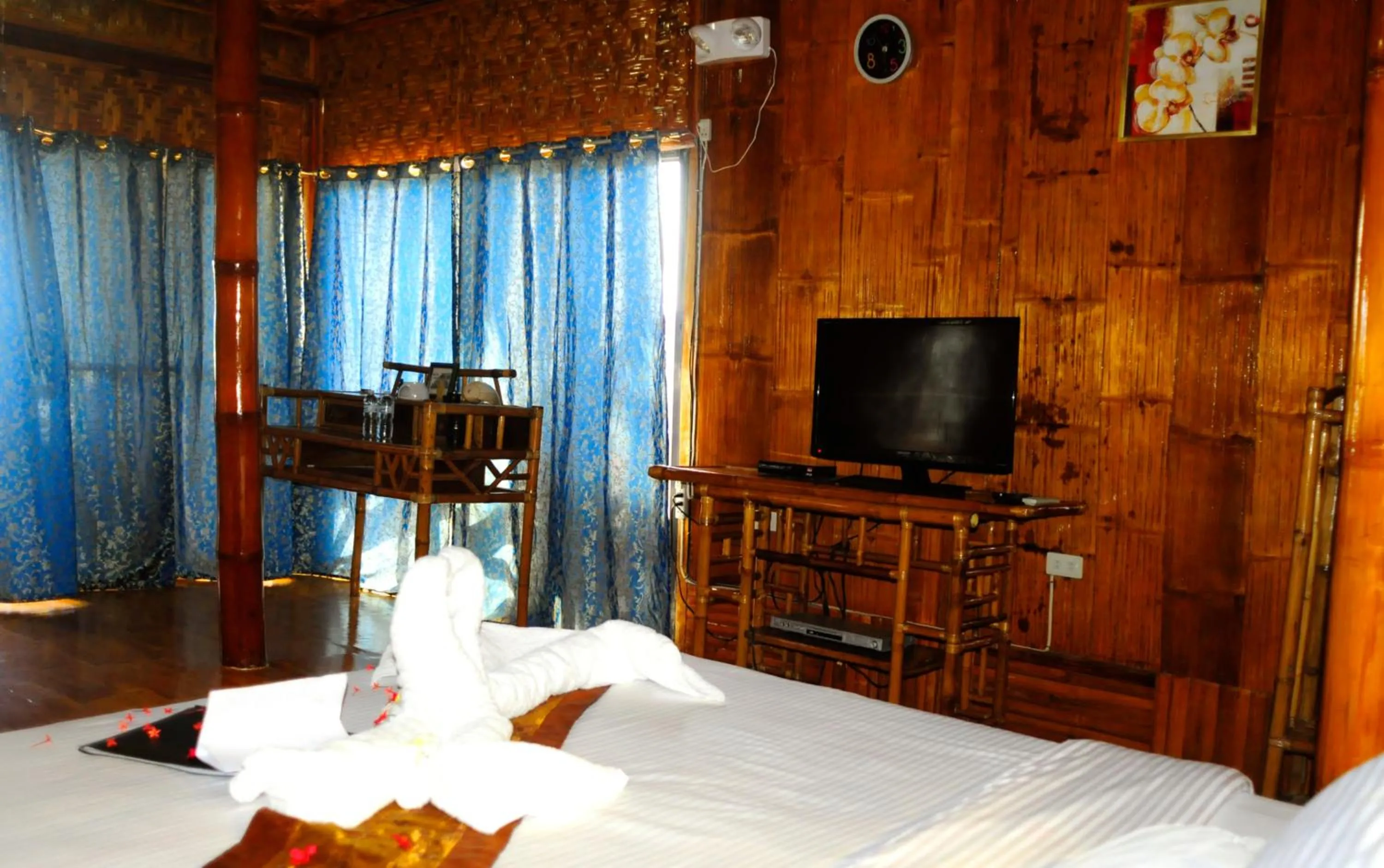 Bed in The Coral Blue Oriental Beach Villas and Suites