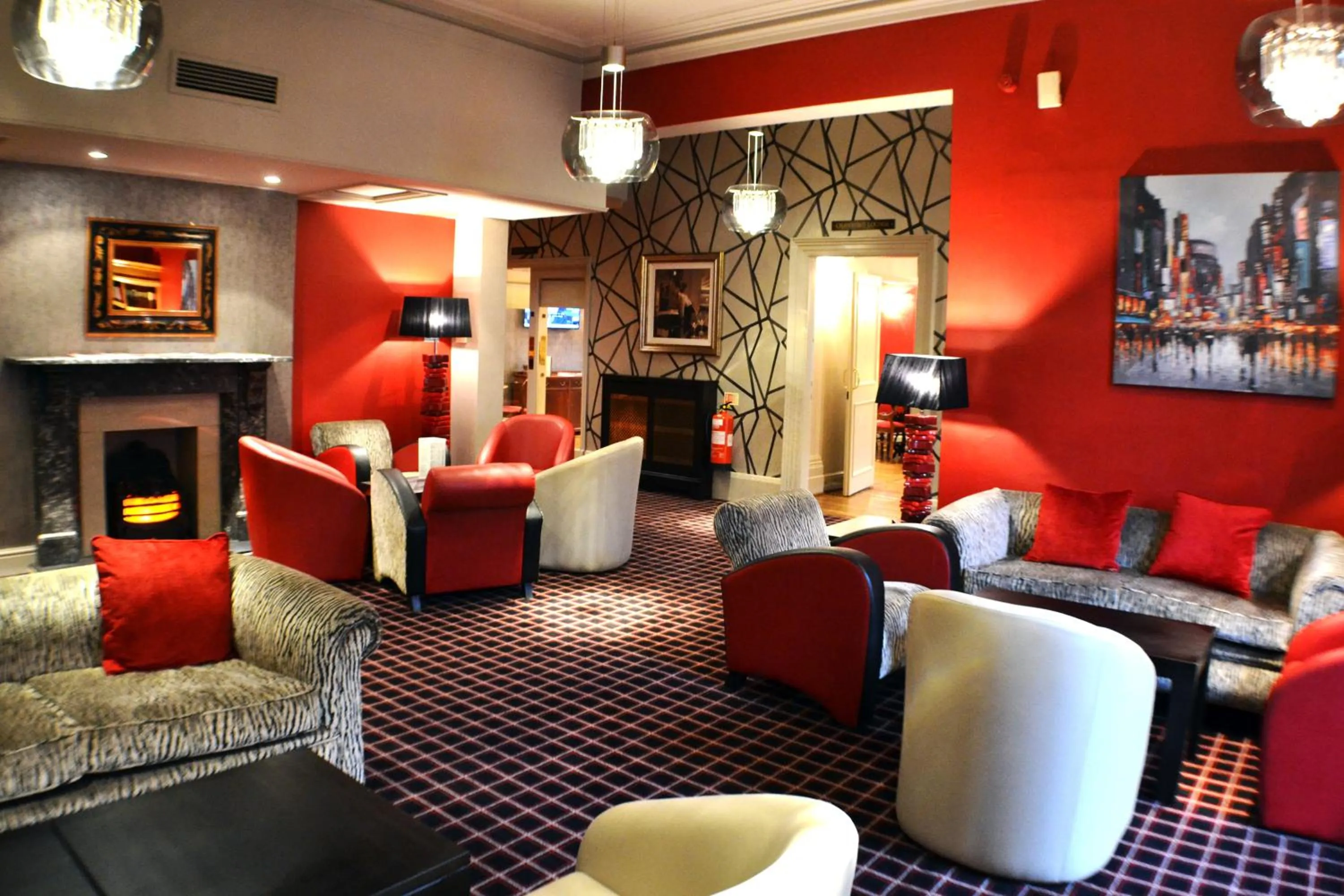 Communal lounge/ TV room in Belmont Hotel Leicester