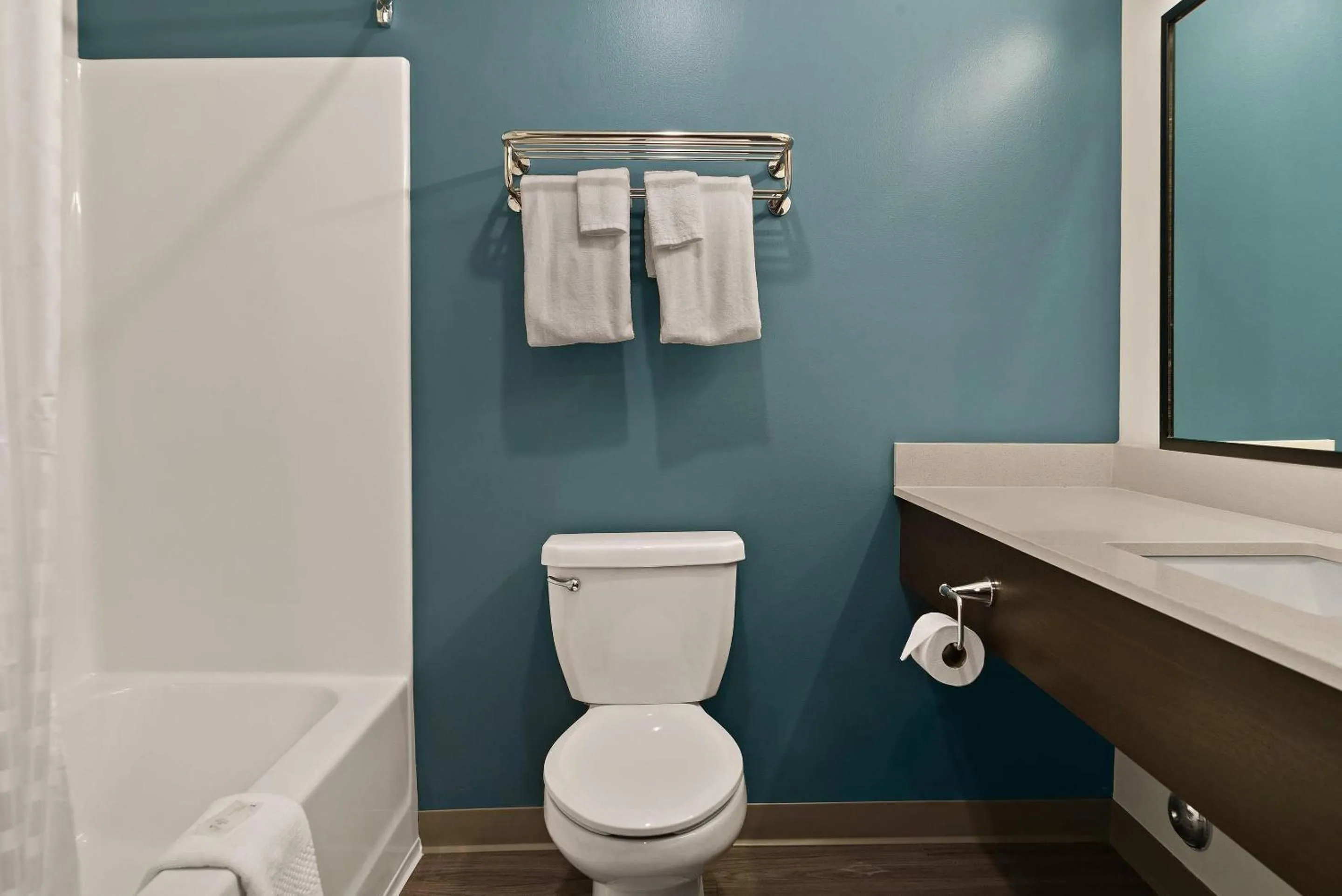 Bedroom in WoodSpring Suites East Lansing - University Area