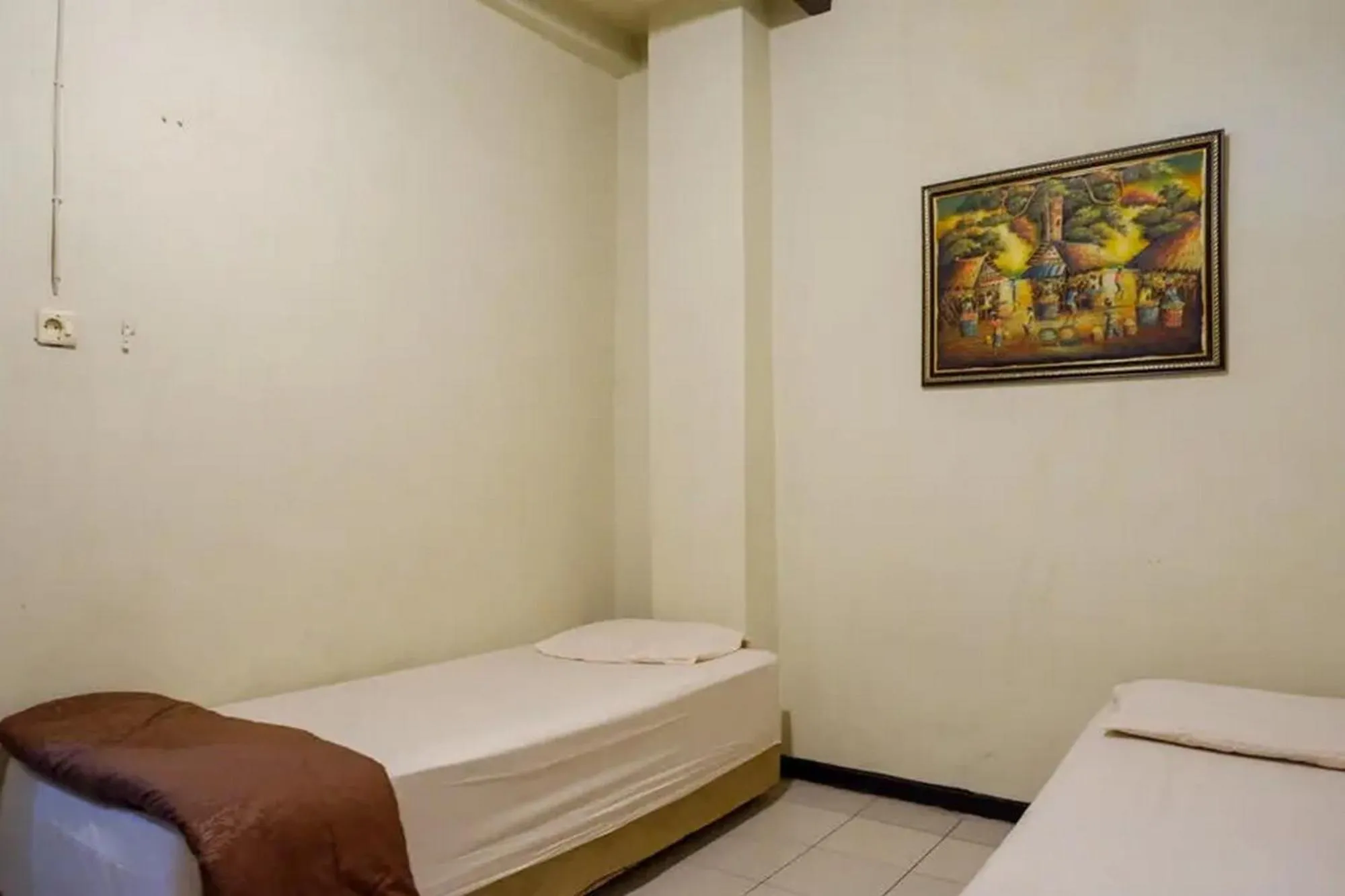 Bed in Cakra Homestay Solo Mitra RedDoorz
