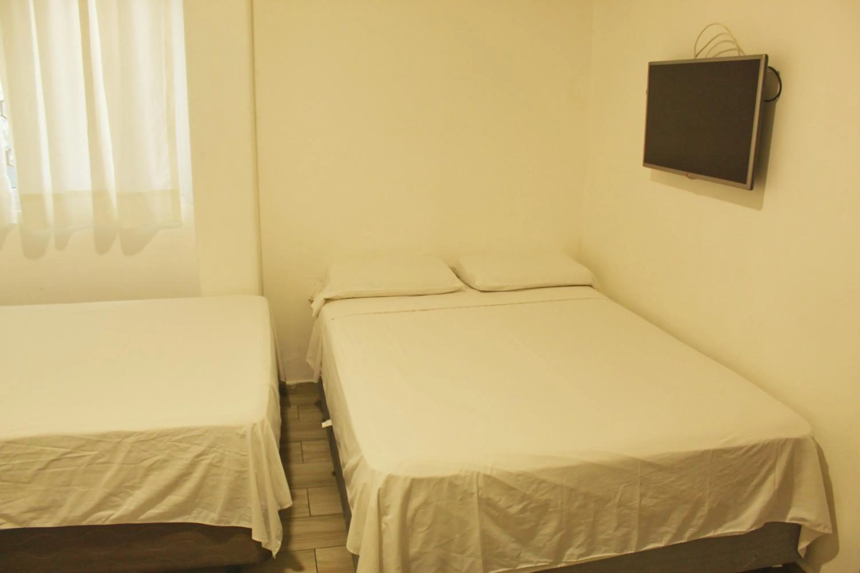 Bed in DC Suites Aeropuerto