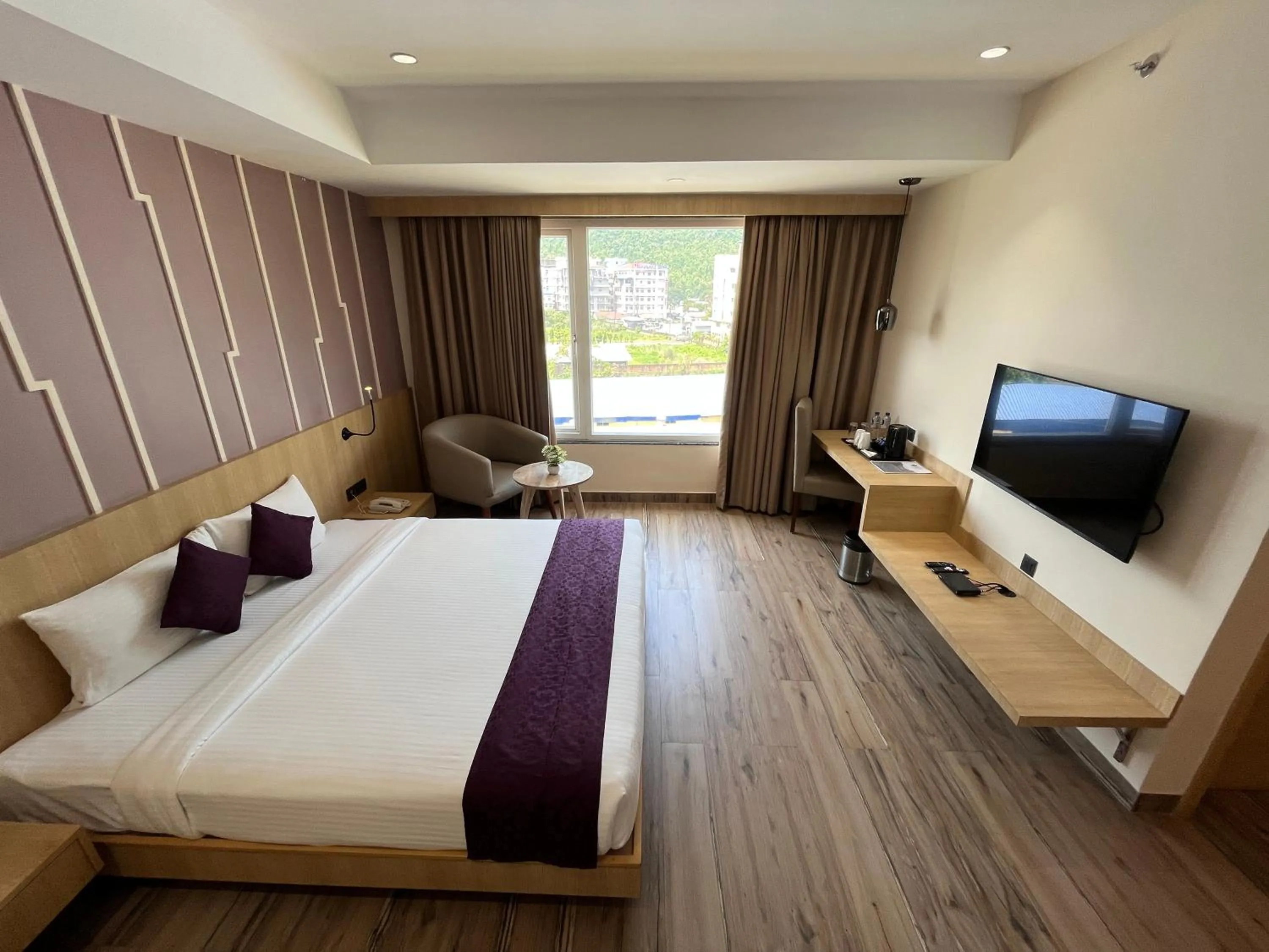 TV and multimedia, Bed in Sachika Hotels, Guwahati